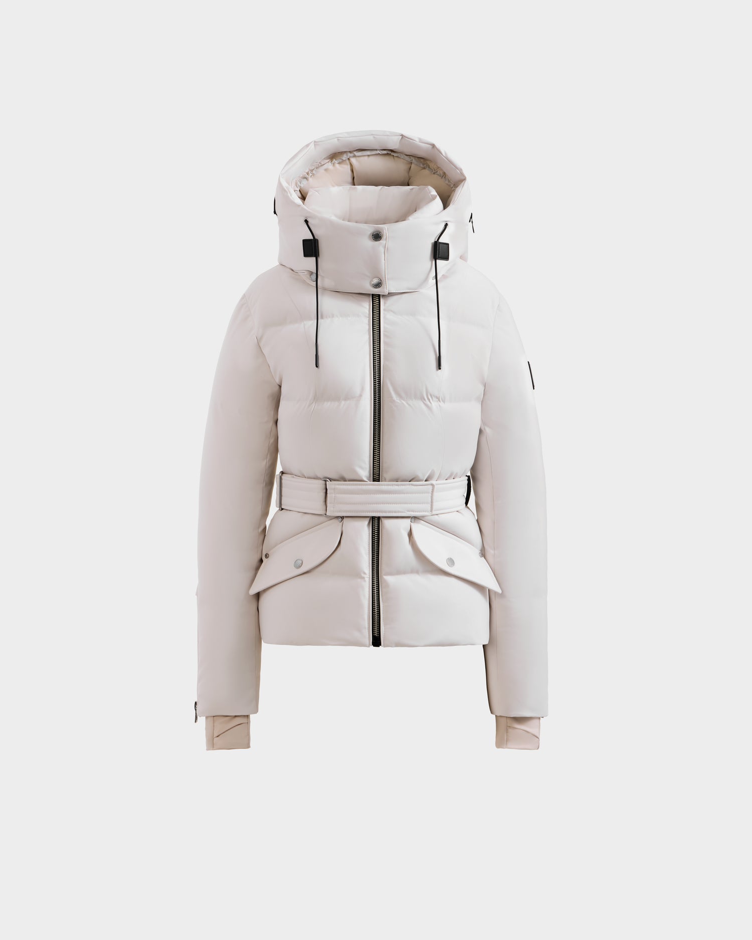 The Rudsak ADELINE H - 8125587 Vanilla women's down puffer features a white hooded design, black zipper and drawstrings, belted waist, and two front flap pockets, shown on a plain white background.