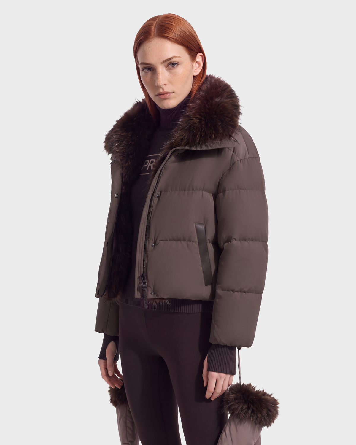 The ALONDRA - 8126992 Espresso is a dark brown, cropped puffer jacket featuring a large fur-trimmed collar and matching fur accents on the cuffs.