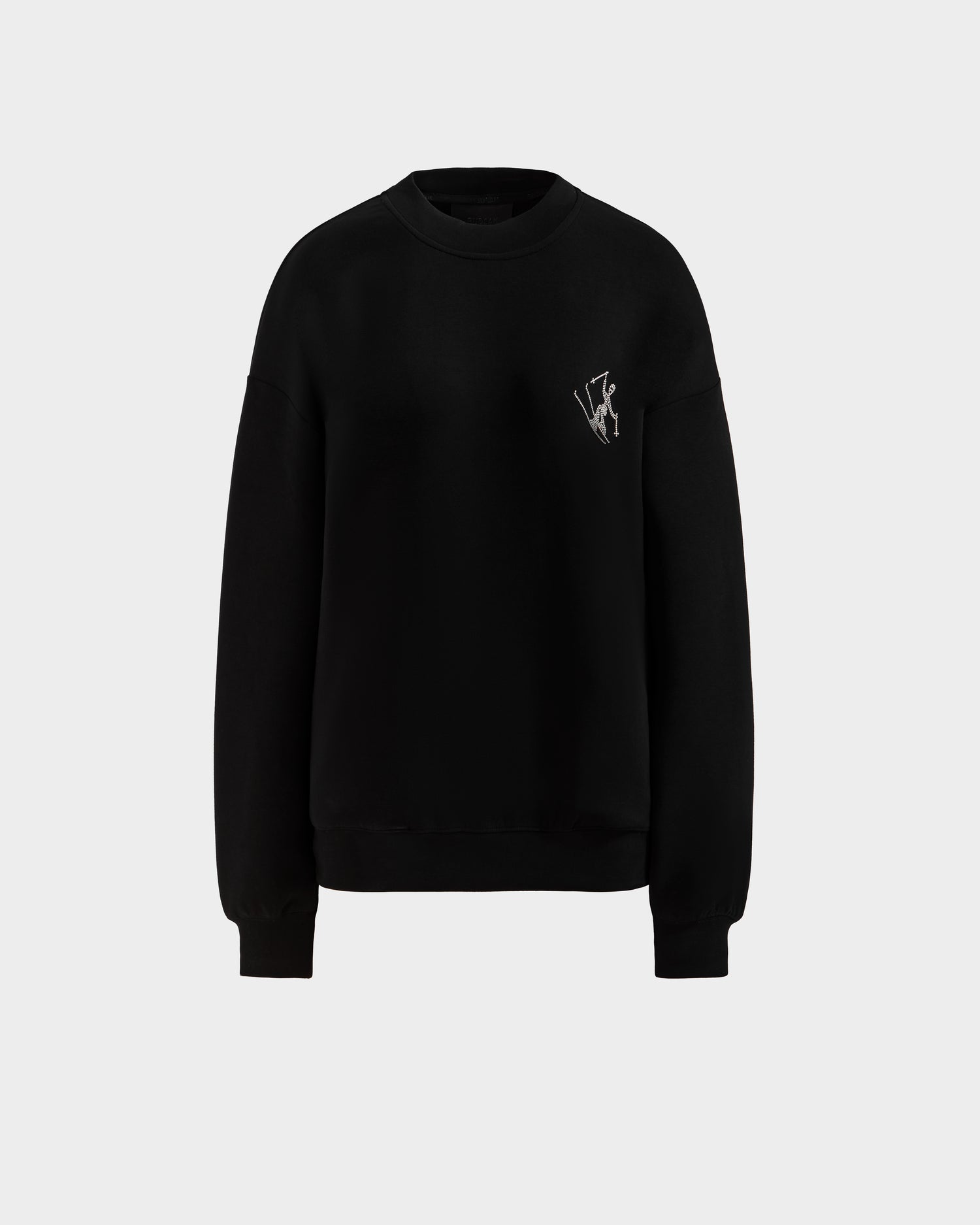 The ARIA - 8525661 Black by Rudsak is a women's plain black crewneck sweatshirt with long sleeves and a small white embroidered logo on the left chest, shown on a light gray background.