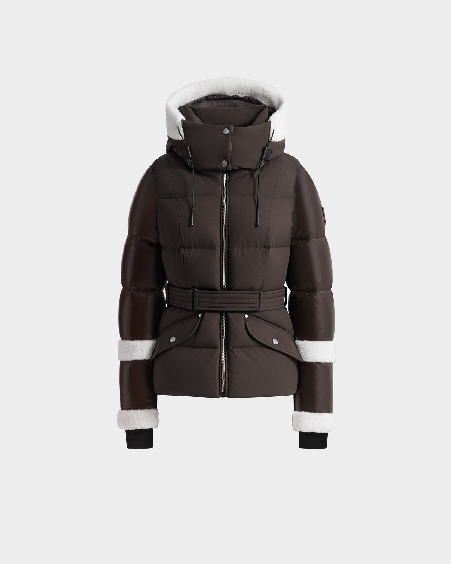 The Rudsak AUDREY - 8124582 Espresso is a dark brown, belted puffer jacket in recycled Stormshell fabric with a high collar, hood, and white shearling trim on the hood and sleeves, shown on a plain white background.