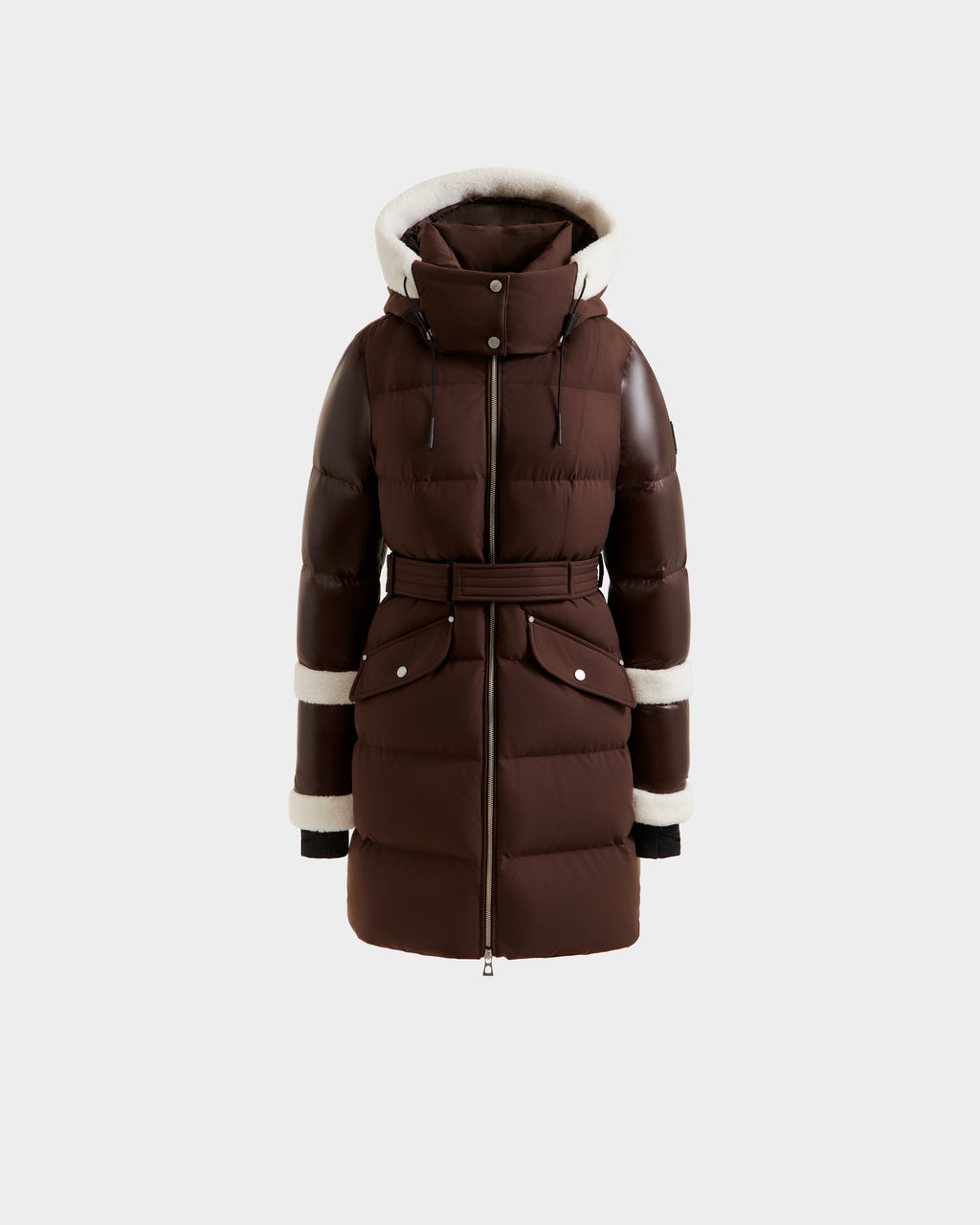 The Rudsak AUDREY L - 8124585 Espresso is a brown, knee-length down puffer jacket with a hood, belted waist, large front pockets, and white shearling trim on the hood, cuffs, and sleeves, shown against a white background.
