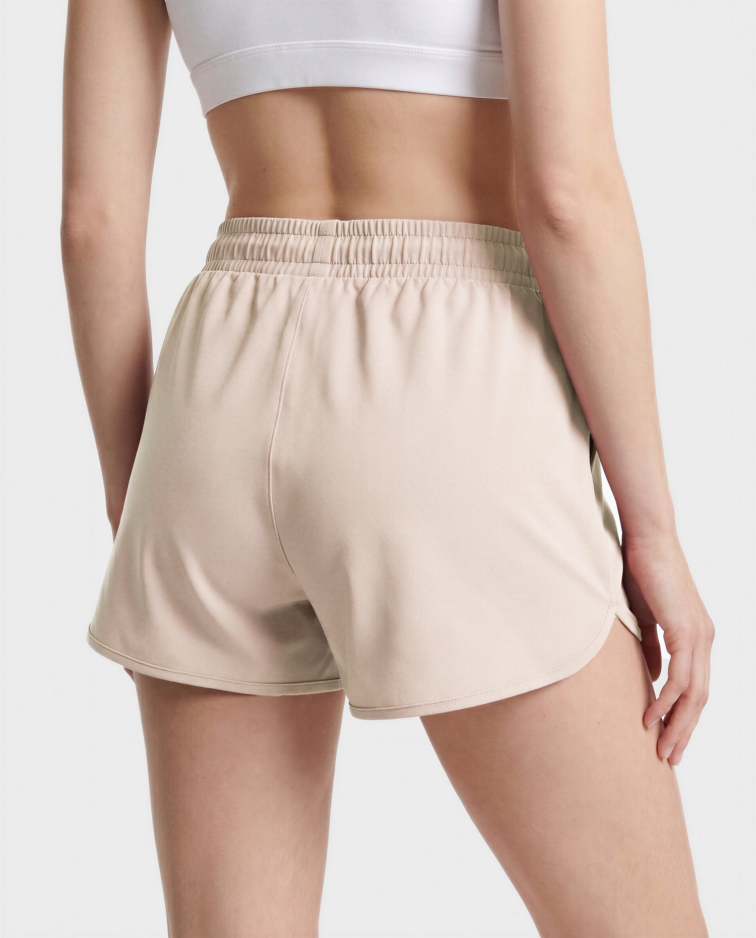 A person wears Rudsak SAMMY - L523014B cream bottoms and a white crop top, standing with their back to the camera against a plain background.