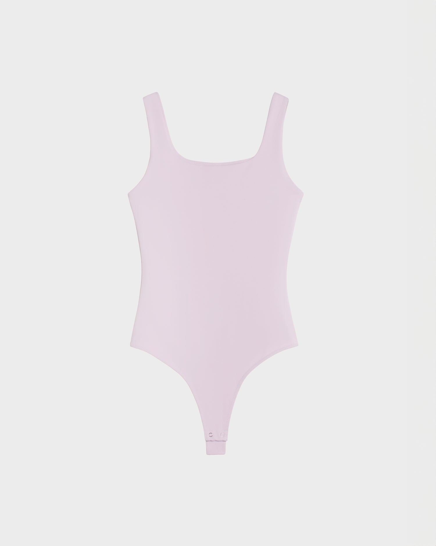 Rudsak BRIDGET - 8524033 Lilac Foam: Women's light pink tank-style bodysuit with a square neckline, sleeveless cut, stretch fabric, and snap closure. Displayed on a plain white background.