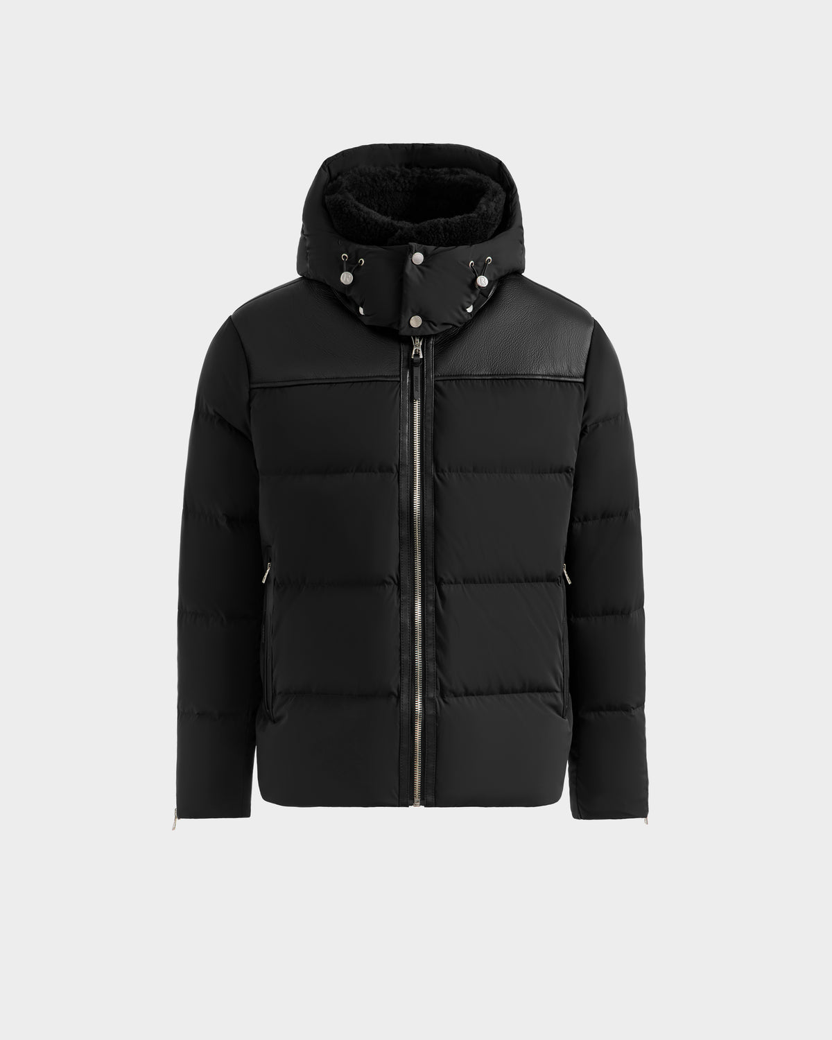 The BALDWIN - 6124507 Black men’s down parka by Rudsak features a high collar, detachable hood, RDS-certified down insulation, front zipper, and snap buttons. Shown on a plain light gray background.