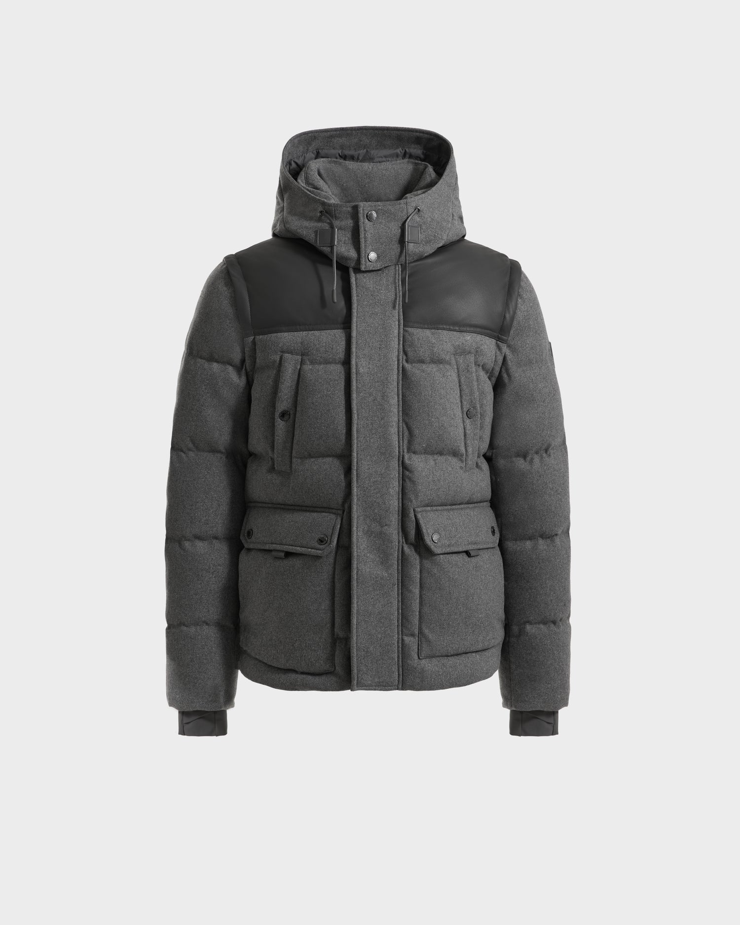The Rudsak BALDWIN W - 6125532 Heather Charcoal is a men’s gray padded down parka with a hood, black shoulder accents, multiple front pockets, and snap button closures—displayed on a plain white background.