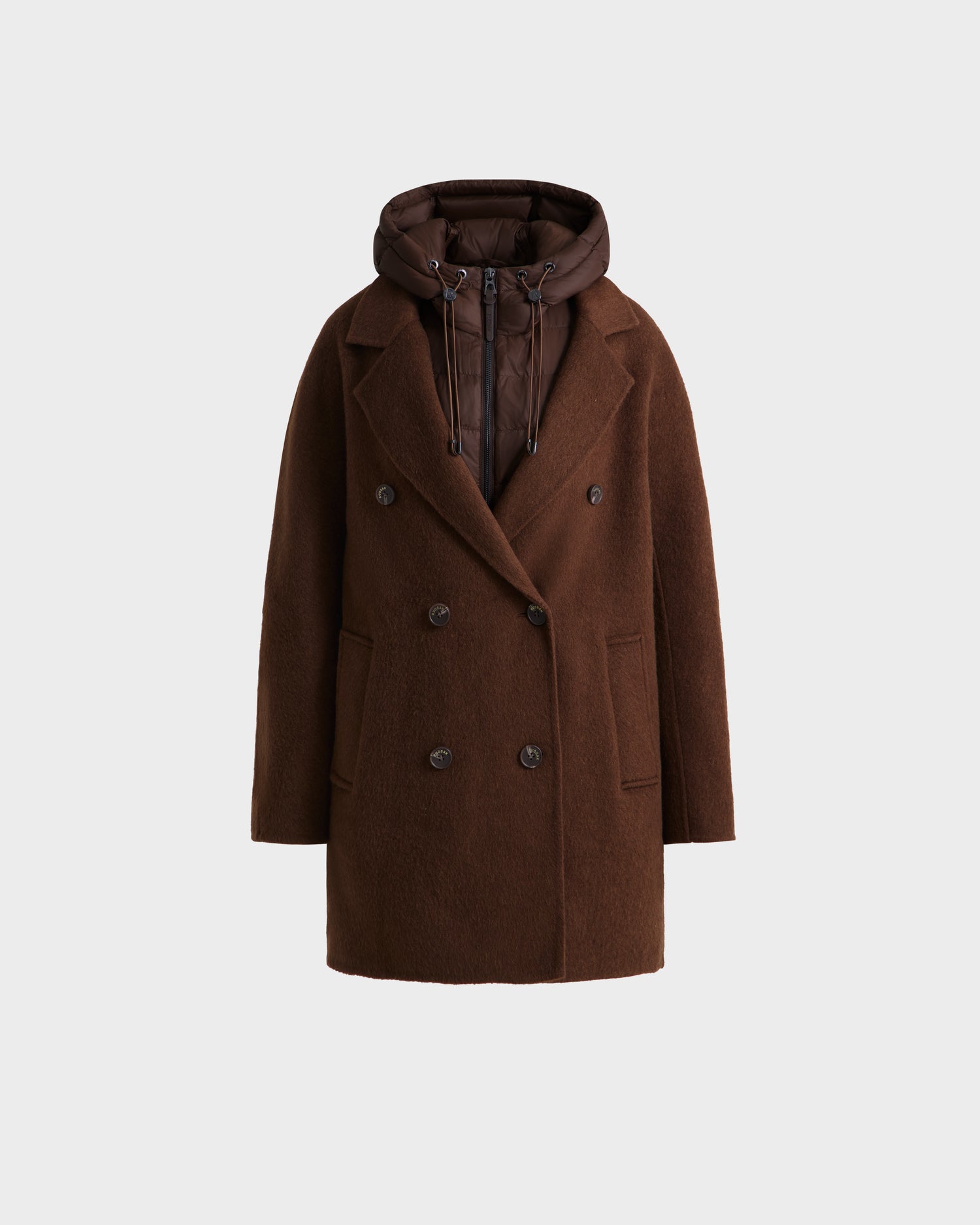 The BETHANY - 8125625 Mocha by Rudsak is a double-breasted modular coat in brown with a notched lapel, large front pockets, and an attached quilted hood, shown against a plain light background.