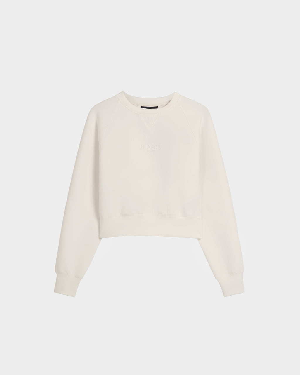 The BETSY - 8525087 Iceland by Rudsak is a women's plain, long-sleeved crop sweater with a crewneck, ribbed cuffs and hem, made from a soft cotton blend, shown against a white background.