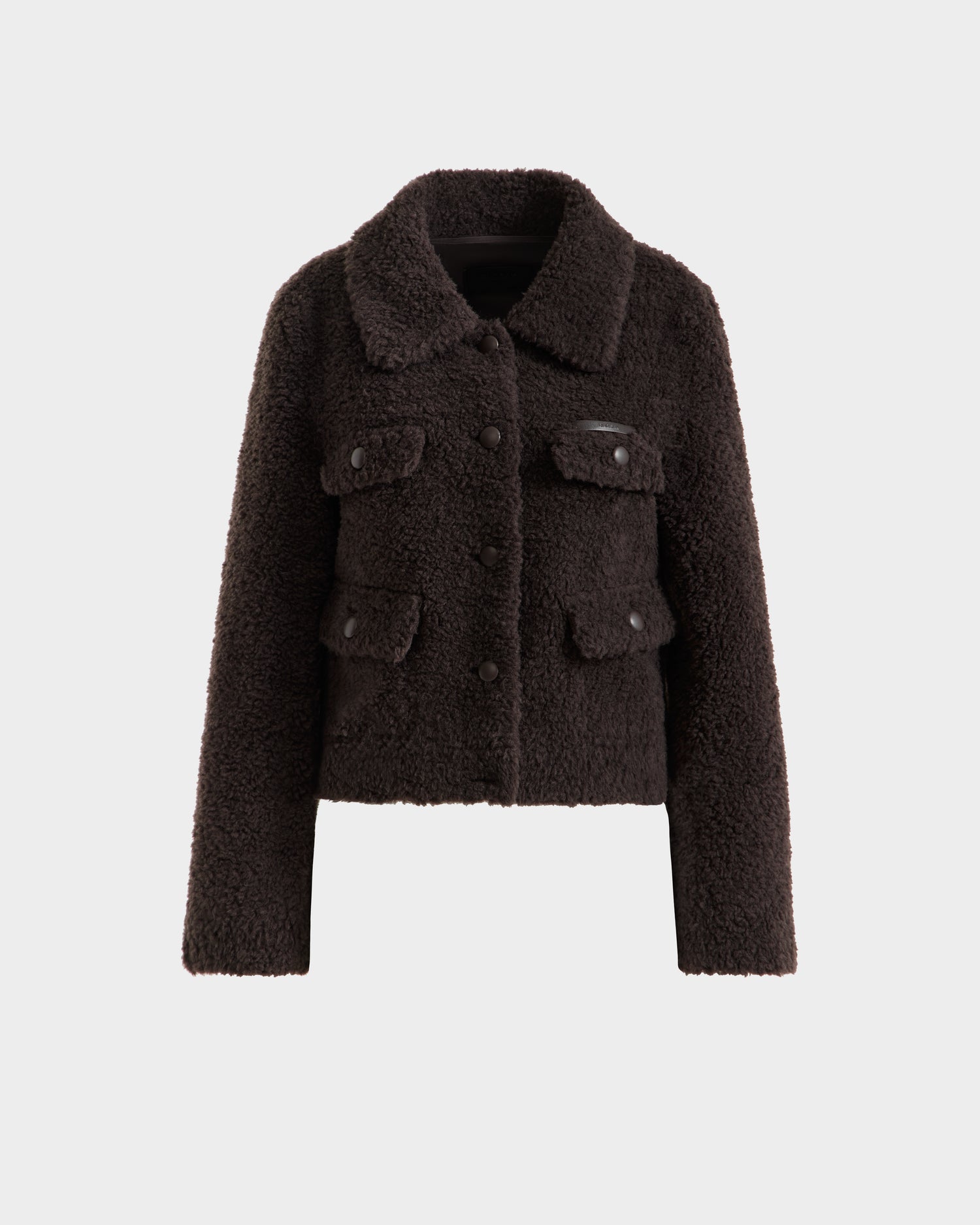 The Rudsak BLAIR - 8125513 Espresso is a dark brown women’s cropped teddy jacket with a collar, long sleeves, front button closure, and four front flap pockets, shown on a plain white background.