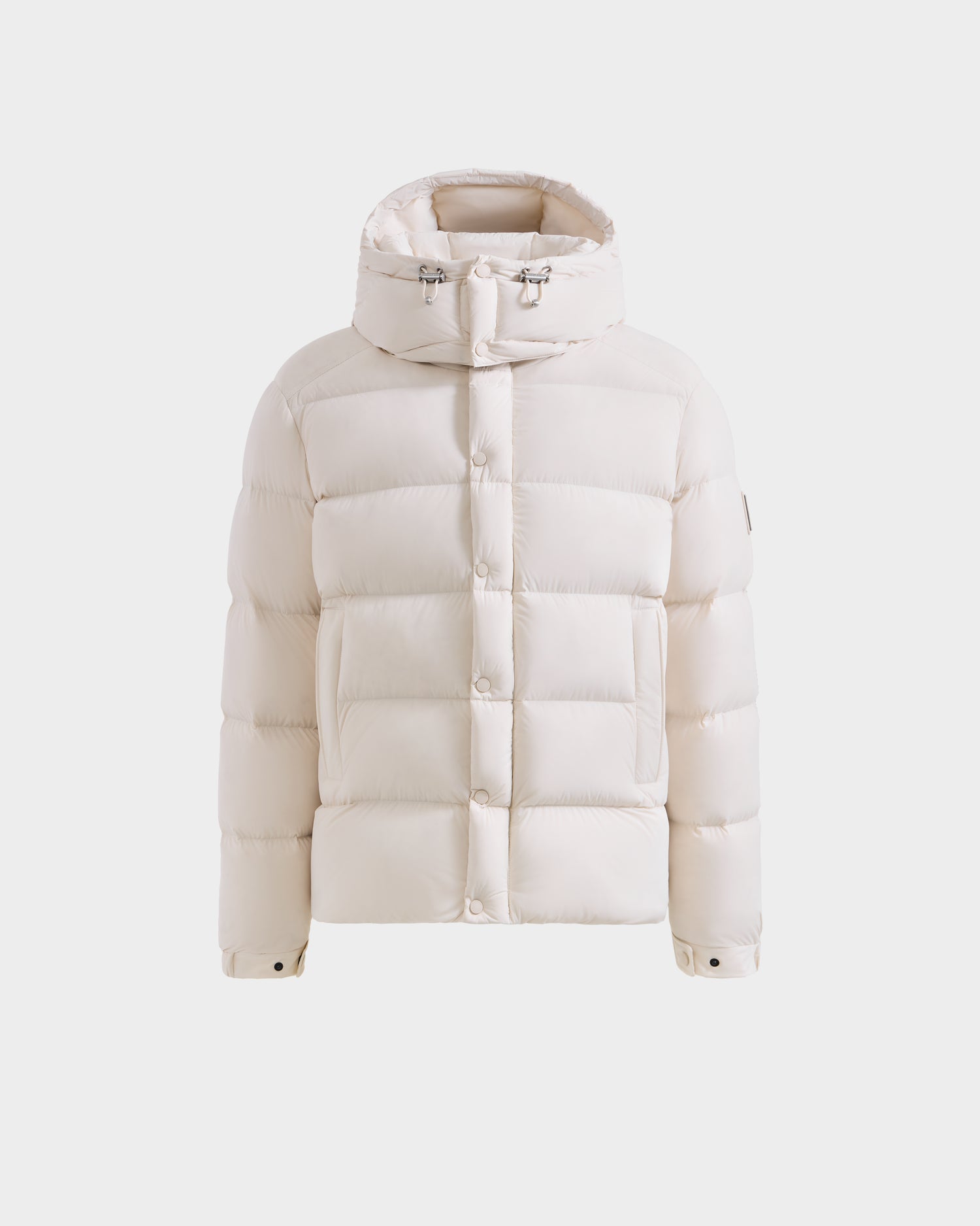 The Rudsak BRAYDEN M-S - M125524 Vanilla is a men's down puffer jacket with a hood, front snap buttons, two side pockets, adjustable hood drawstrings, and RDS-certified down, shown against a plain white background.
