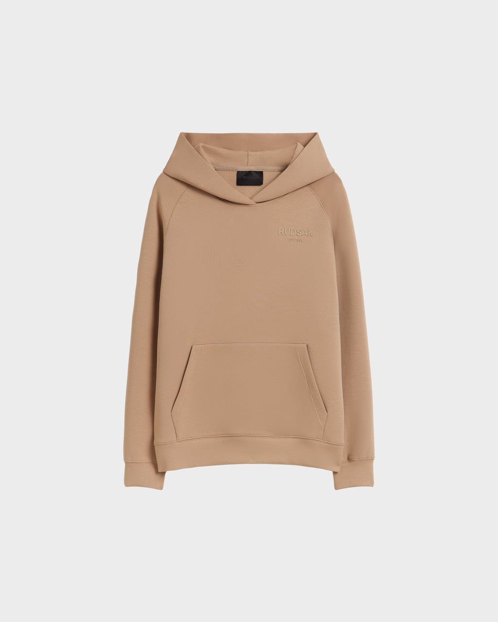 The BRIAR - 9525001 Almond M by Rudsak is a tan unisex hoodie made from a premium cotton blend, featuring long sleeves, a front kangaroo pocket, and a subtly embroidered RUDSAK logo on the chest against a white background.