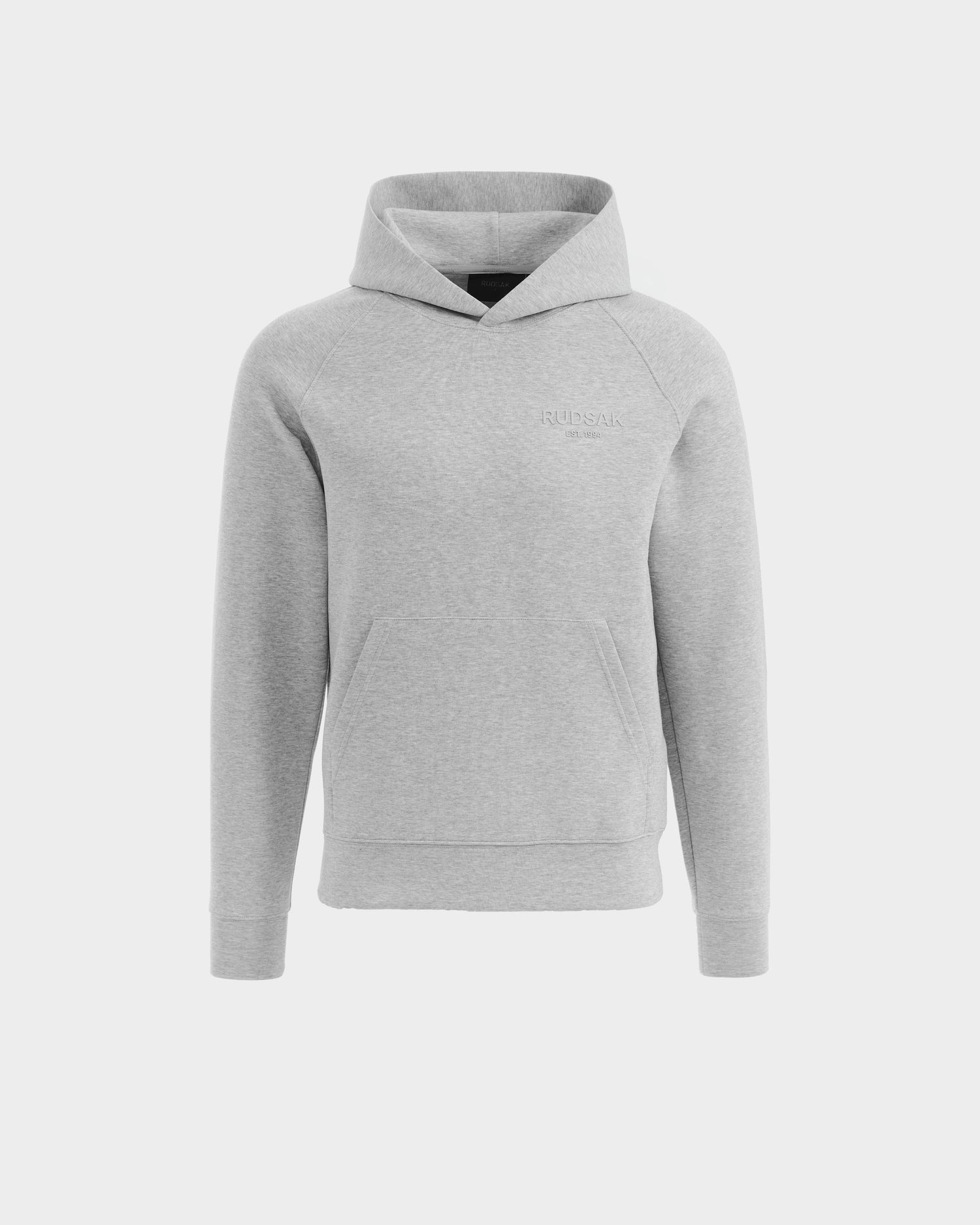 The Rudsak BRIAR - 9525001 hoodie in heather grey (size M) is a unisex cotton-blend piece with long sleeves, a front kangaroo pocket, and subtle RUDSAK text on the left chest, shown on a plain white background.