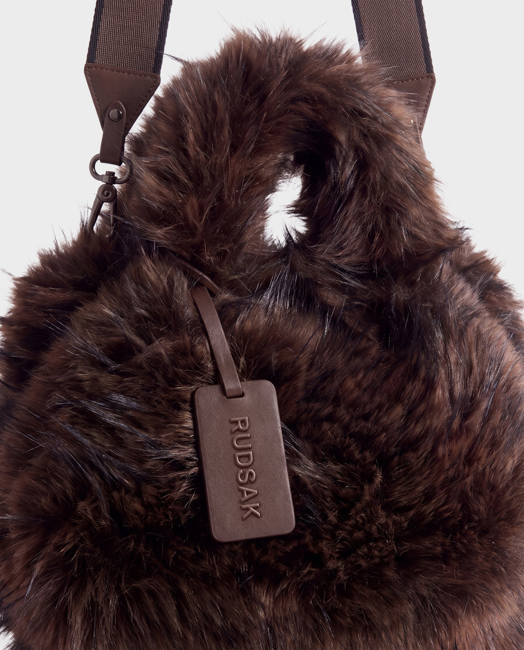 Rudsak CABAS - 8325545 Mix Expresso dark brown faux fur mini tote featuring a matching luggage tag and an adjustable shoulder strap, a statement accessory for winter layers.