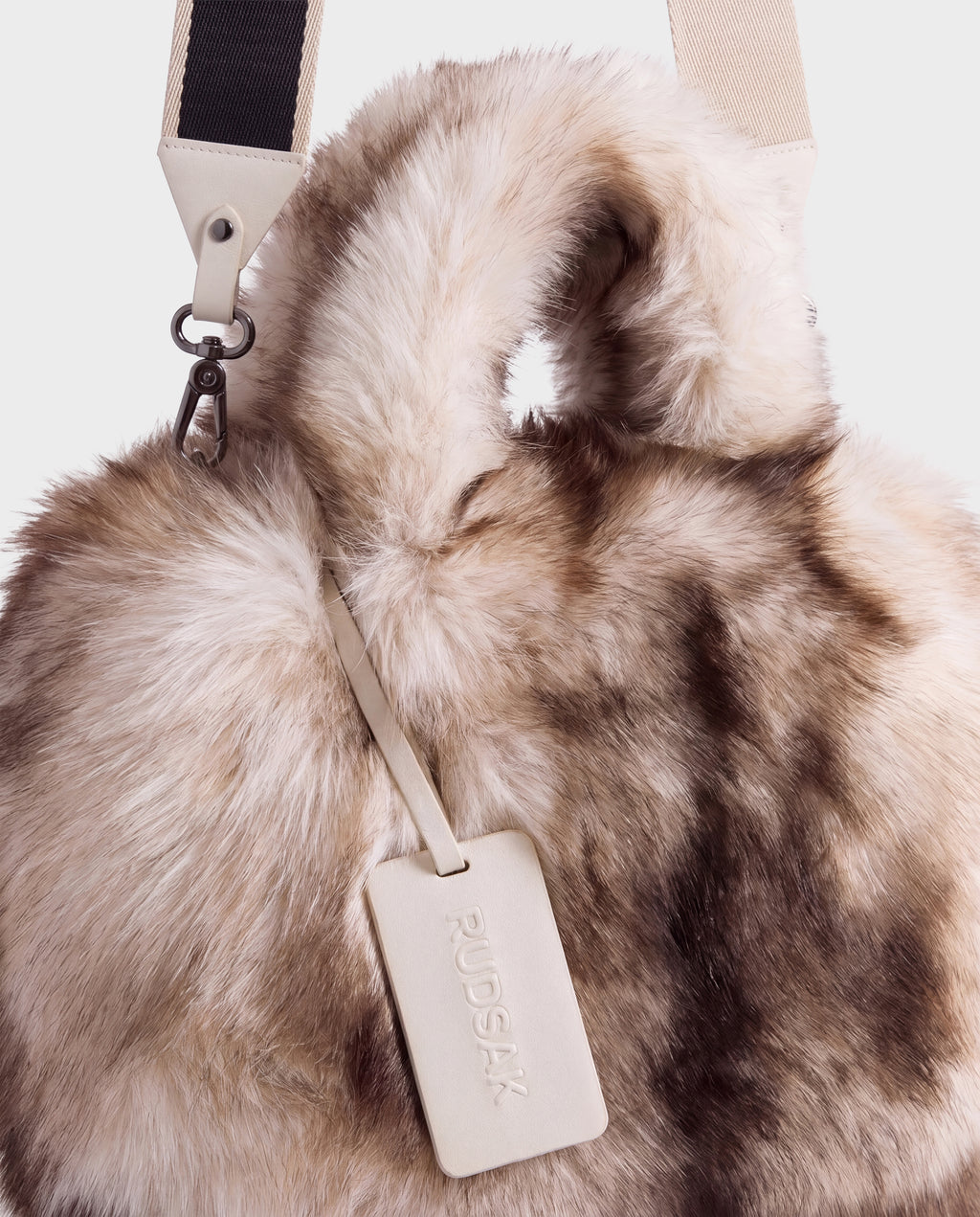 CABAS - 8325545 Mix Vanilla fluffy faux fur mini tote featuring top handles, a detachable shoulder strap, and a branded luggage tag, perfect for styling with winter layers.