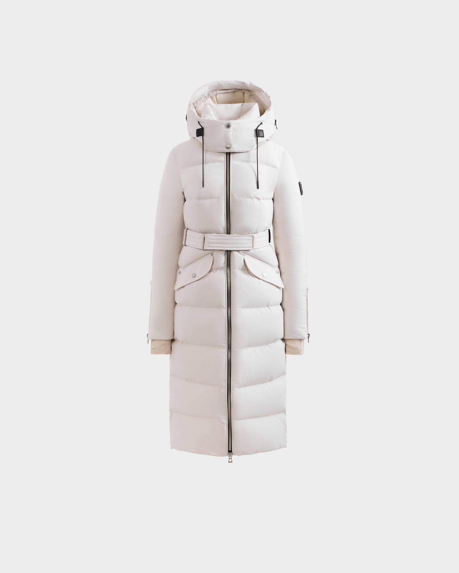 The Rudsak CALI H - 8125614 Vanilla is a women’s white long down parka with a belted waist, zip-up front, large pockets, high-loft down fill, and a removable hood, shown on a plain light background.