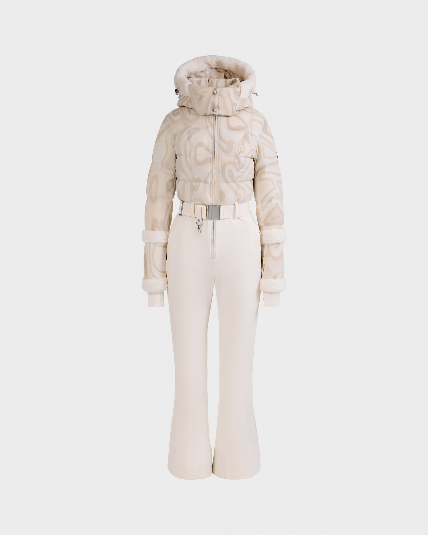 The Rudsak CARMEN P - 8125707 Vanilla Deja vu is a stylish cream snowsuit with a printed puffer jacket, fur-trimmed hood, belted waist, and matching fitted snow pants, shown on a white background.