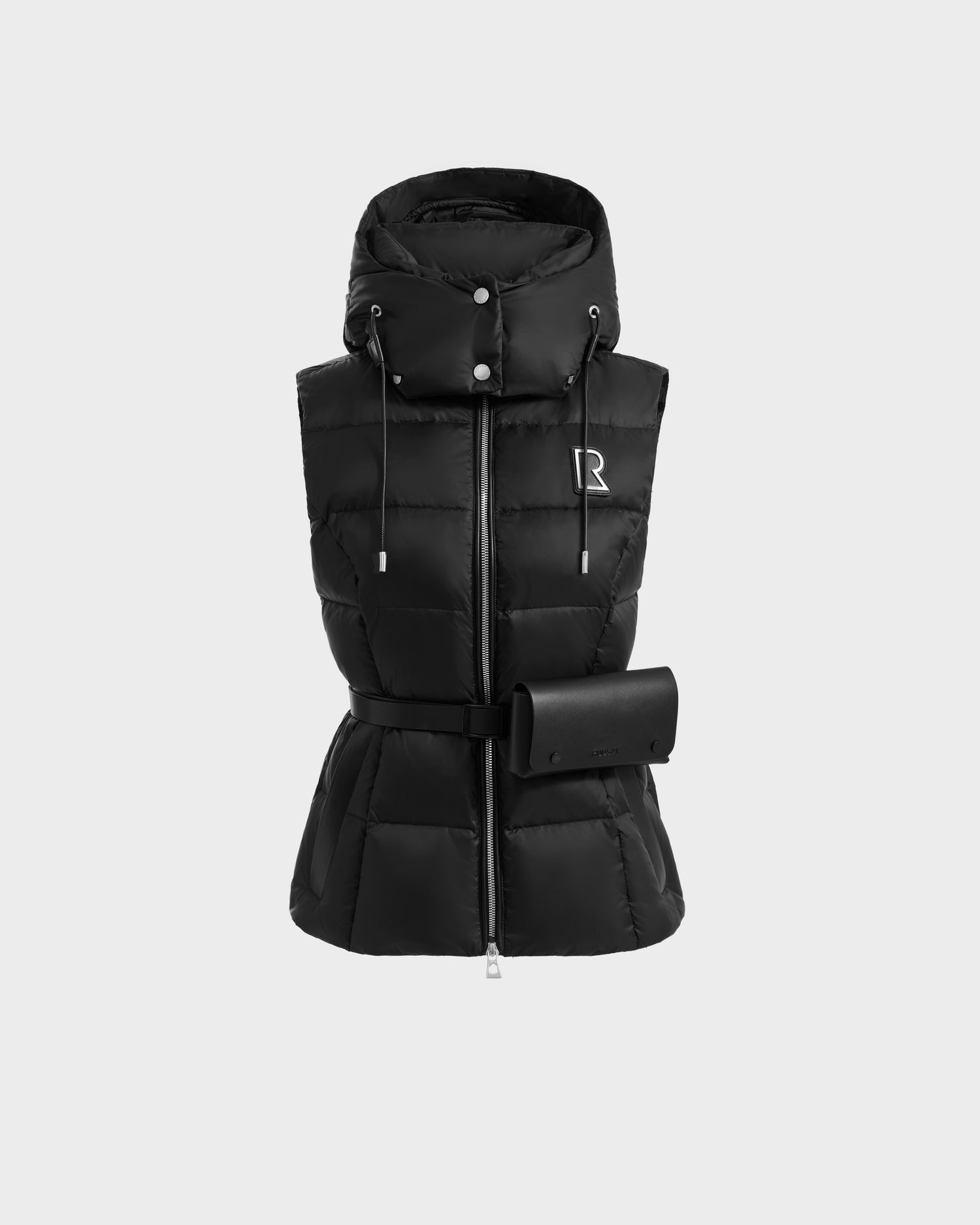 The CASSIDY N - 8125677 Black by Rudsak is a women’s fitted, black sleeveless down vest with high collar, hood, silver zipper, drawstrings, matching belt with pouch, and a subtle R logo on the upper left chest for lightweight warmth.