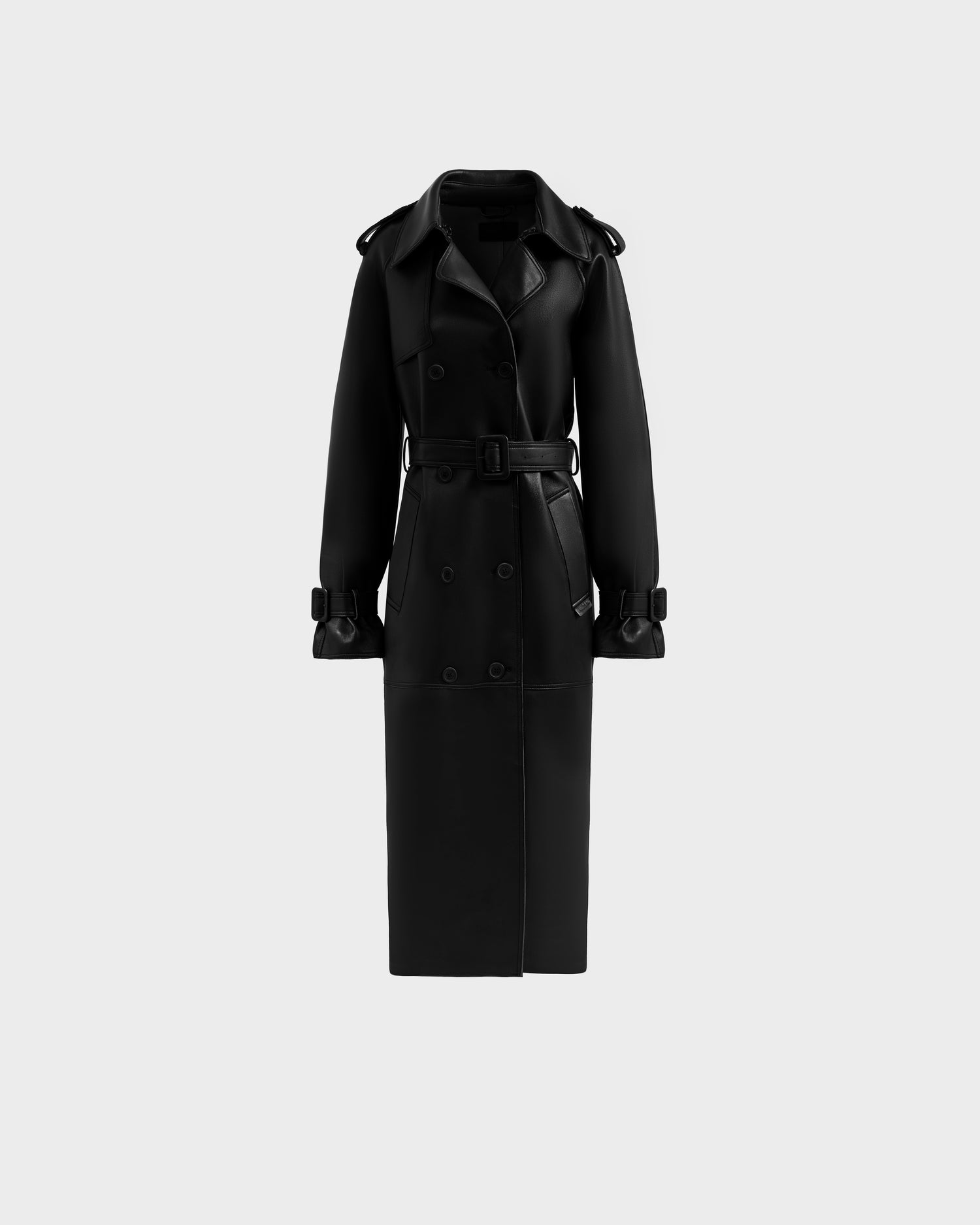 The Rudsak CASSIE L-B - 8125553 is a long black trench coat featuring a belted waist, wide lapels, and buttoned cuffs, shown on a plain light gray background.