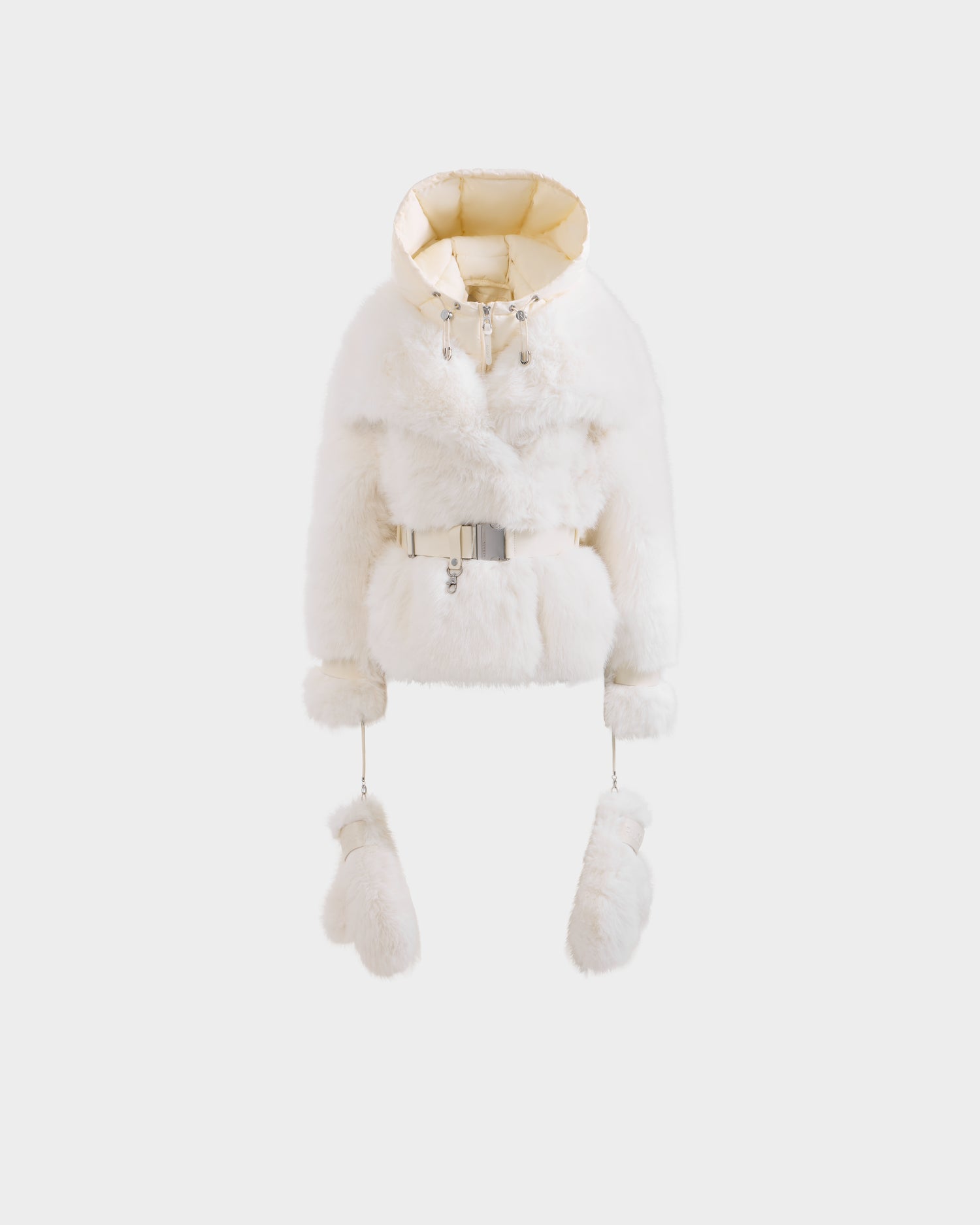 The CHLOE - 8125619 Iceland by Rudsak is a white women’s cropped faux fur jacket with a shiny beige lining, silver buckle belt, and matching fur mittens on cords, displayed on a plain white background.