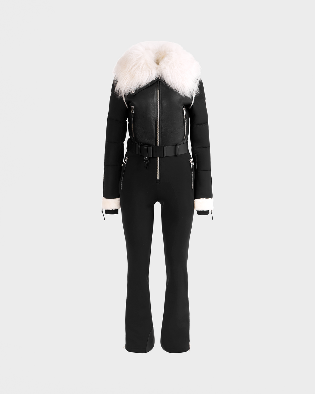 The Rudsak CHYNTIA - 8125611 Black is a black fitted jumpsuit with a wide white faux fur collar, belted waist, zipper details, and white faux fur cuffs. Displayed on a headless mannequin. Pre-order now; ships by November 30th.