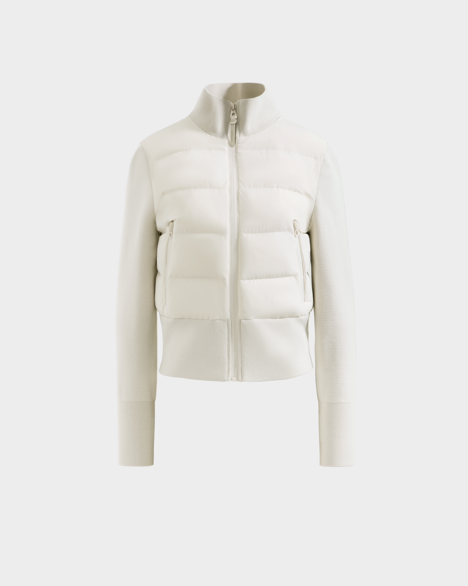 The Rudsak CLAREMONT - 8125502 Vanilla is a cream-colored women’s short down jacket with long sleeves, zip-up front, high collar, and ribbed cuffs for lightweight warmth, shown on a plain white background.