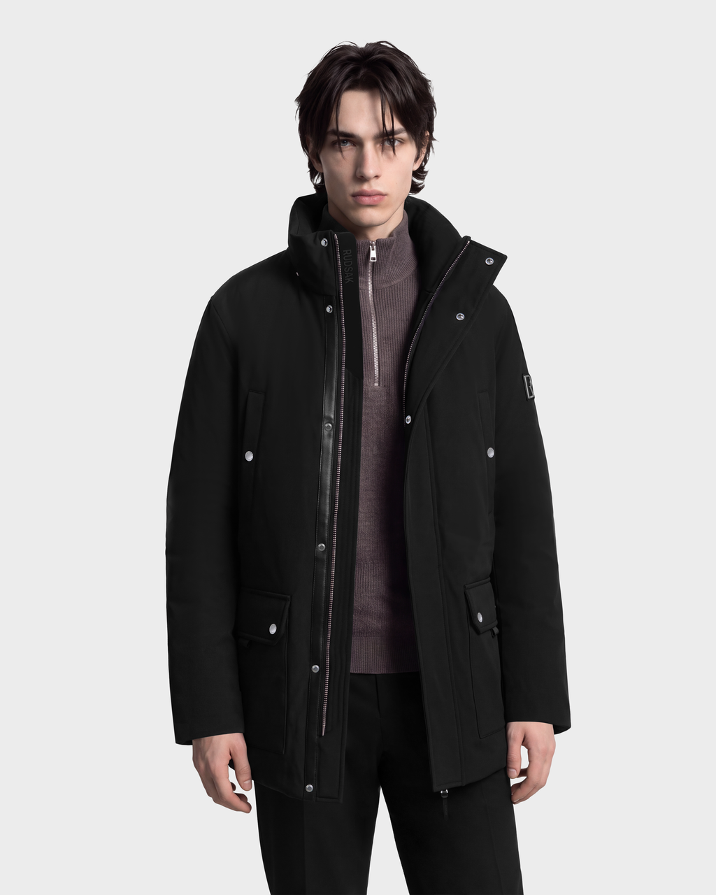 Man wearing an EDWARD - 6126501 Black duck down winter parka over a grey quarter-zip sweater.