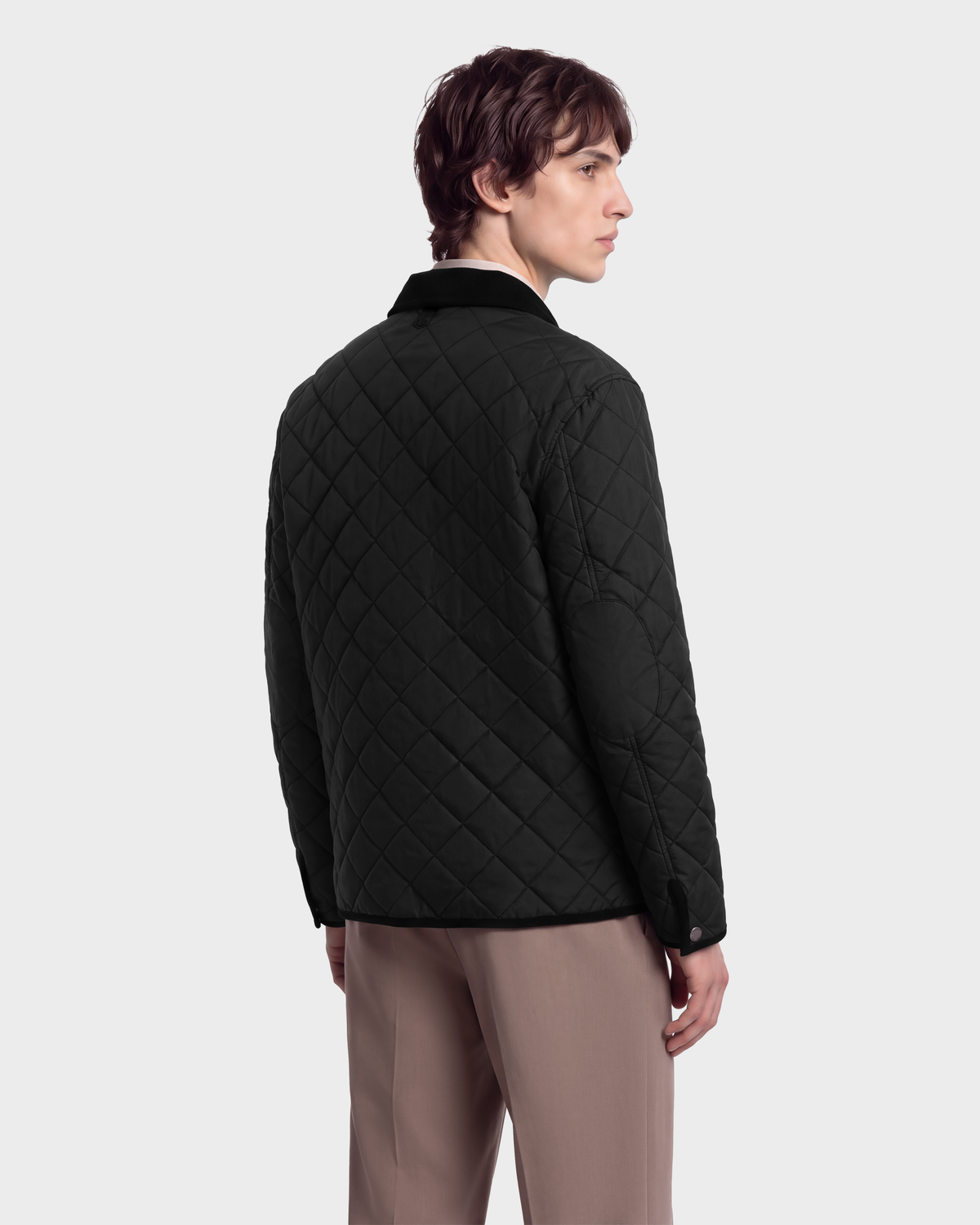 A person seen from the back wearing a black Rudsak MONTY - 6126722 Black quilted jacket with a contrasting collar.