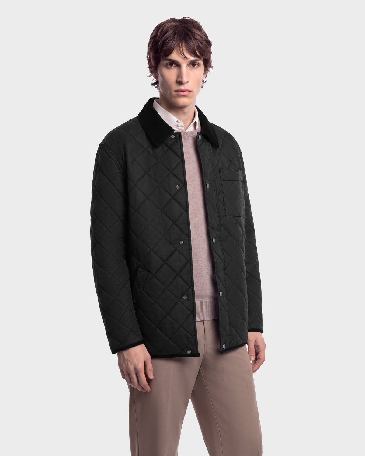 A man wearing a MONTY - 6126722 Black quilted jacket with a corduroy collar over a light-colored sweater and dress pants.