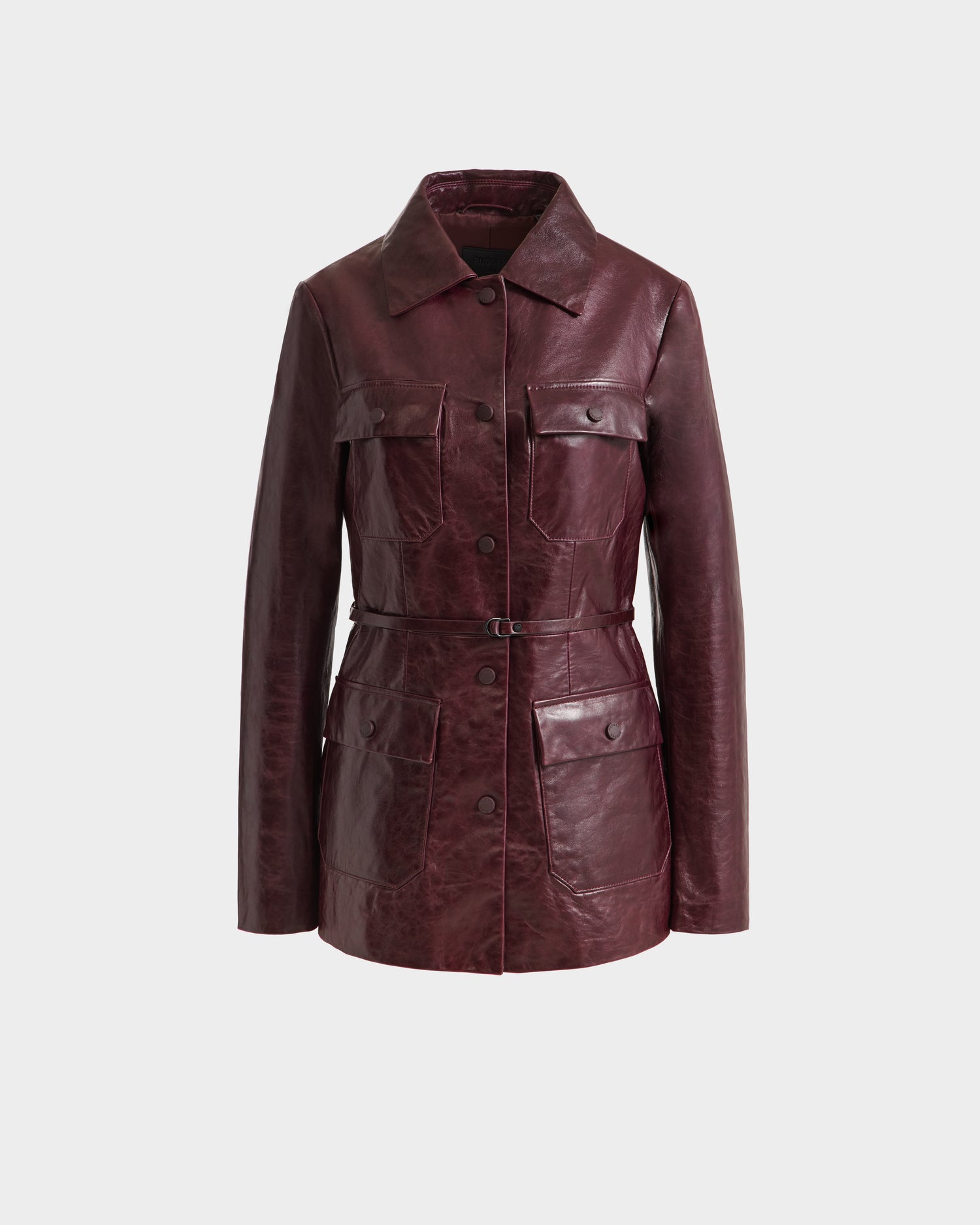 The Rudsak DANICA - 8125025 Bordeaux is a womens dark burgundy leather jacket with a tailored fit, collar, button closure, long sleeves, and four front flap pockets, shown against a plain white background.