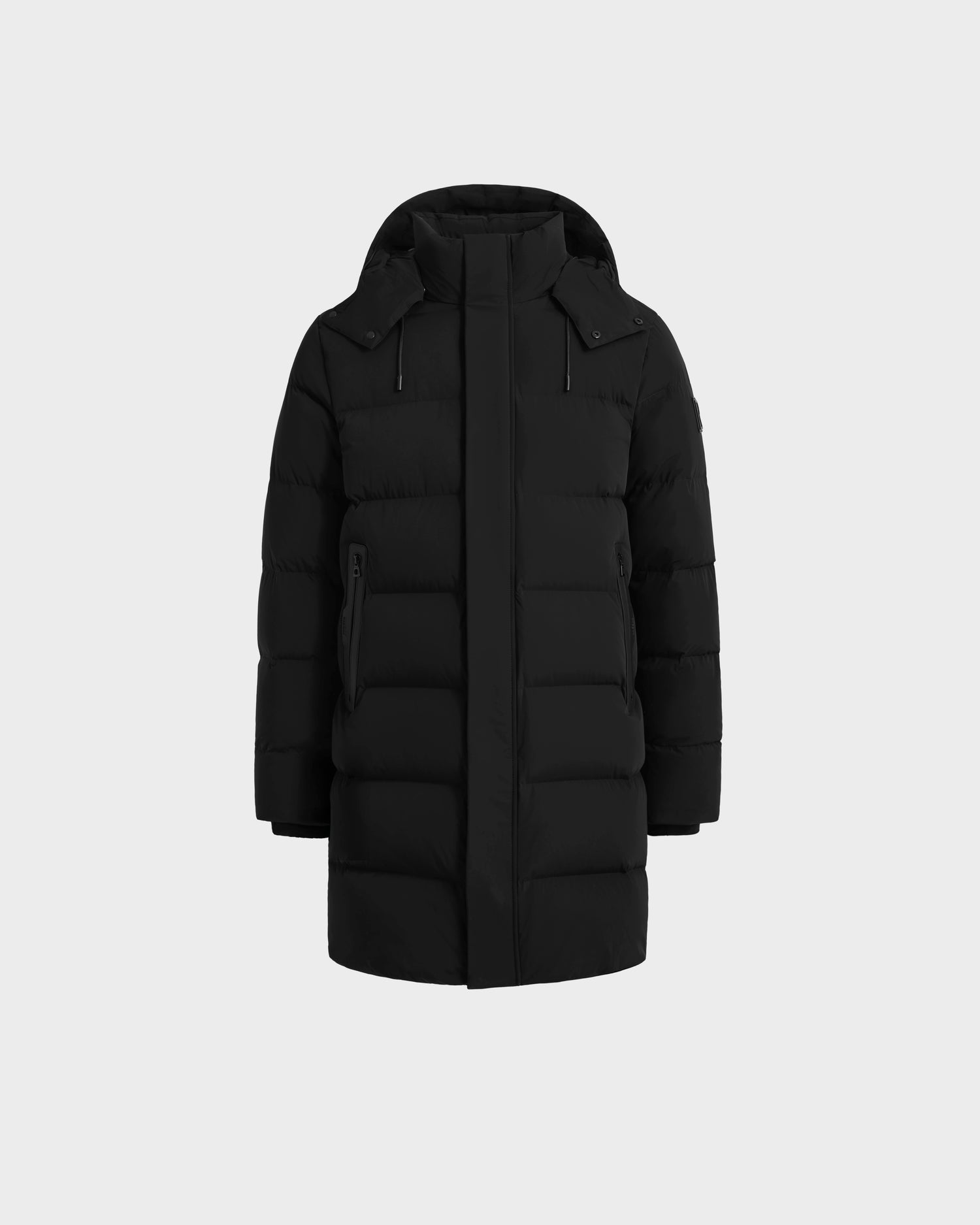 The Rudsak DAO - 6124604 Black is a long black mens puffer jacket with a hood, front zipper, and two side pockets, displayed against a light gray background—a stylish winter option designed for warmth.