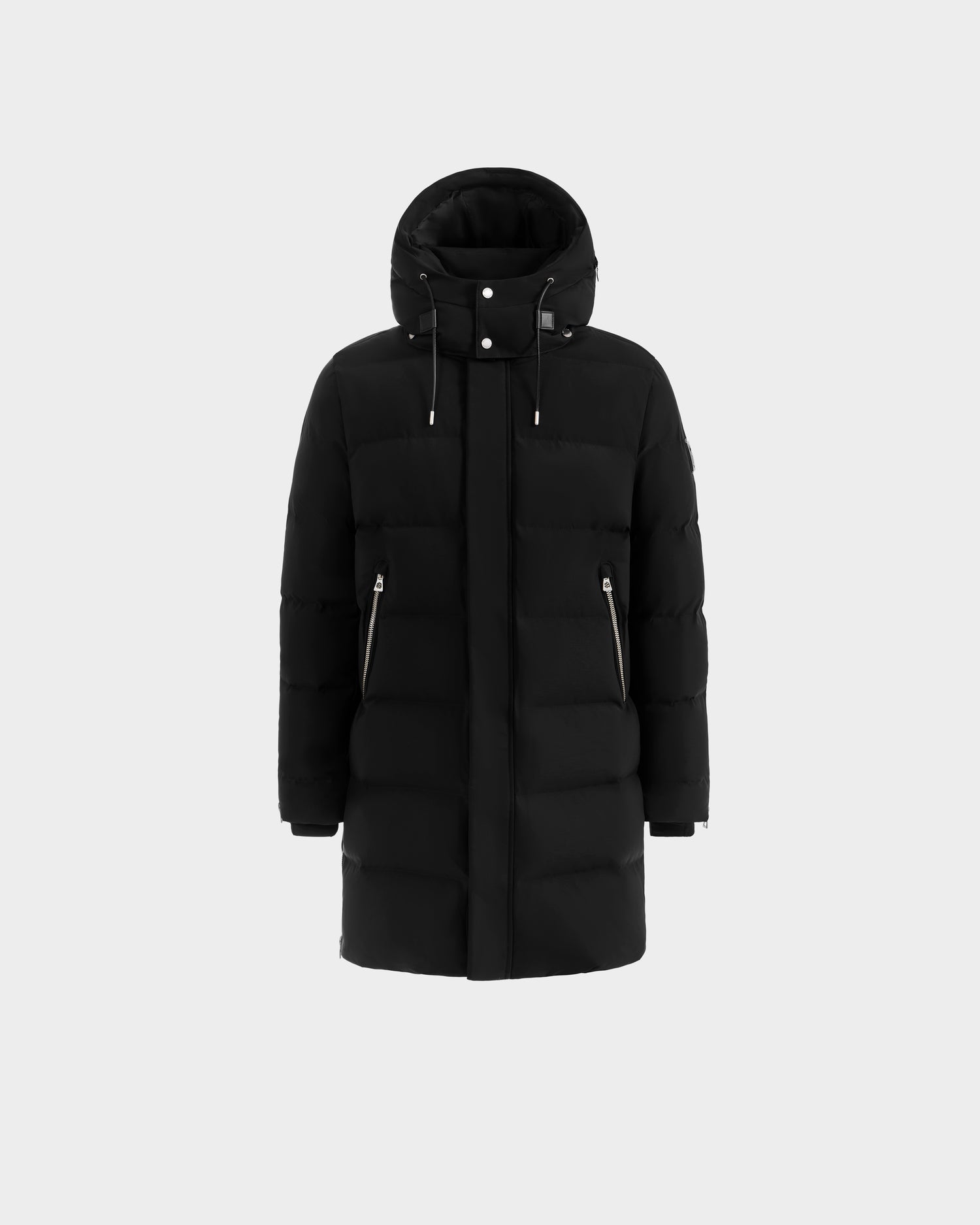 The Rudsak DAO H - 6125583 Black is a men’s long quilted down puffer with a hood, front zipper, snap buttons, and two slanted zippered pockets, shown against a plain white background—perfect for cold-weather style.