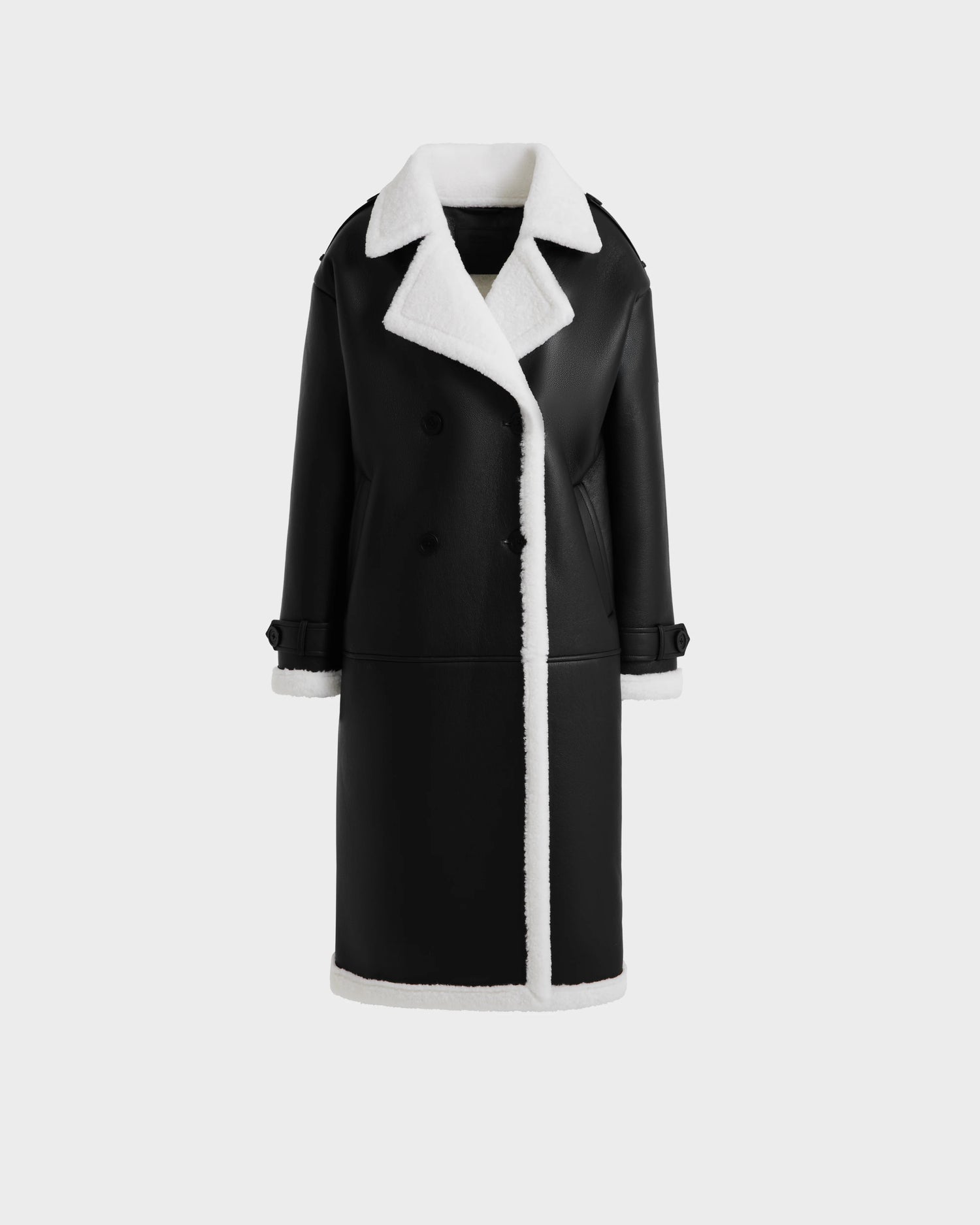 The Rudsak DARCY - L125539 Black is a women’s vegan leather overcoat with white shearling trim and a faux sherpa teddy lining, shown against a plain light gray background.