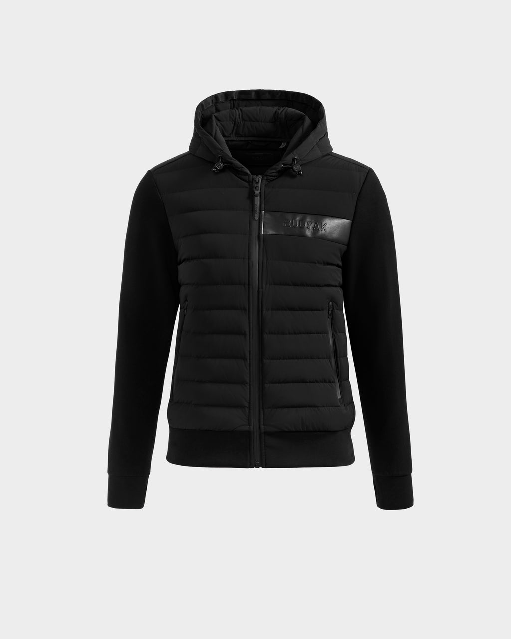 The Rudsak DEE MP - 6125673 Black is a black urban hooded jacket with a quilted front, zip pockets, ribbed cuffs, full zip closure, and subtle shiny logo on the chest. Filled with RDS-certified duck down for warmth. Photographed on a light gray background.