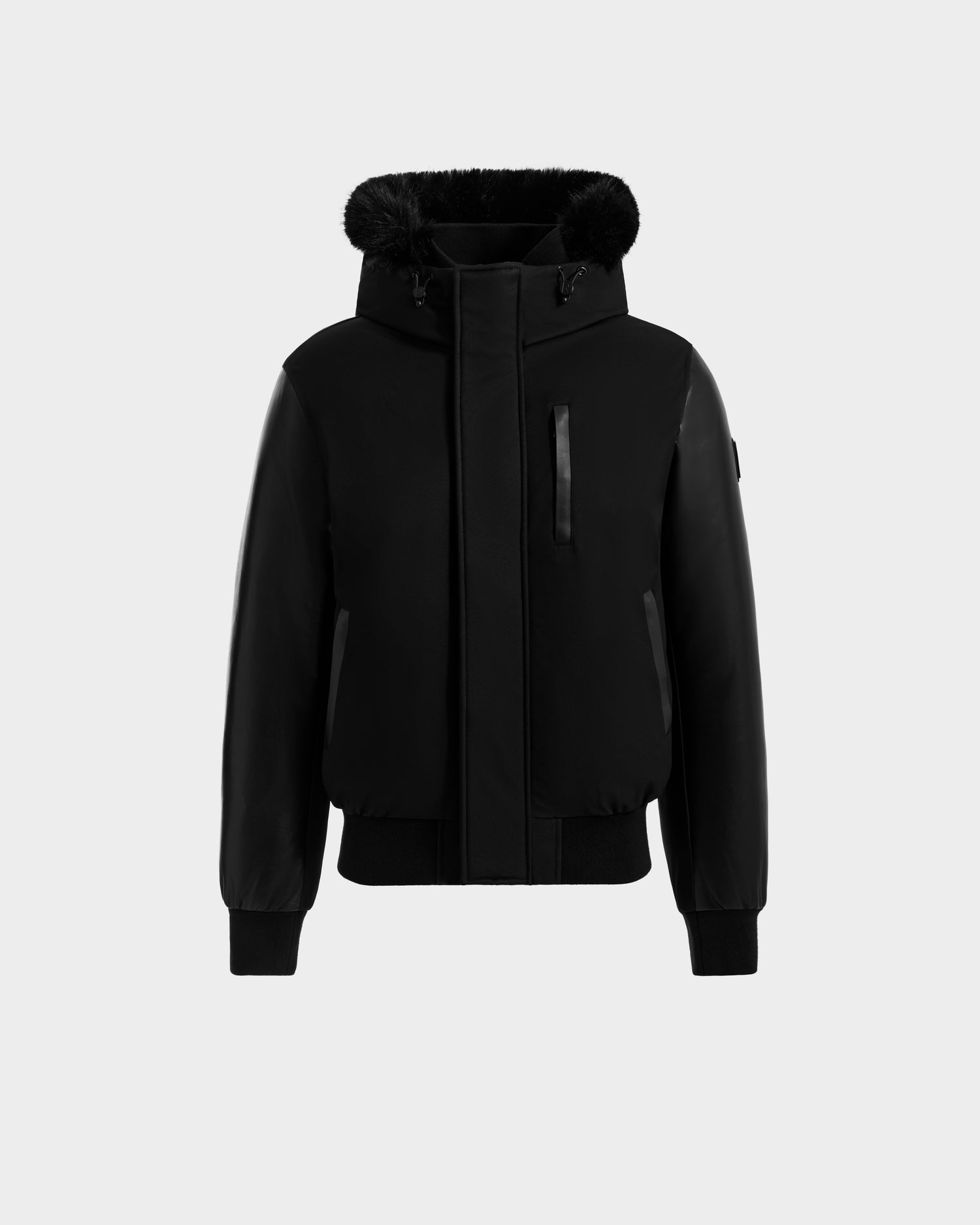The Rudsak DERON - M125539 Black men’s down bomber jacket features vegan-leather sleeves, a fur-lined hood, front zipper, chest zip pocket, and ribbed cuffs and hem, shown on a plain light grey background.