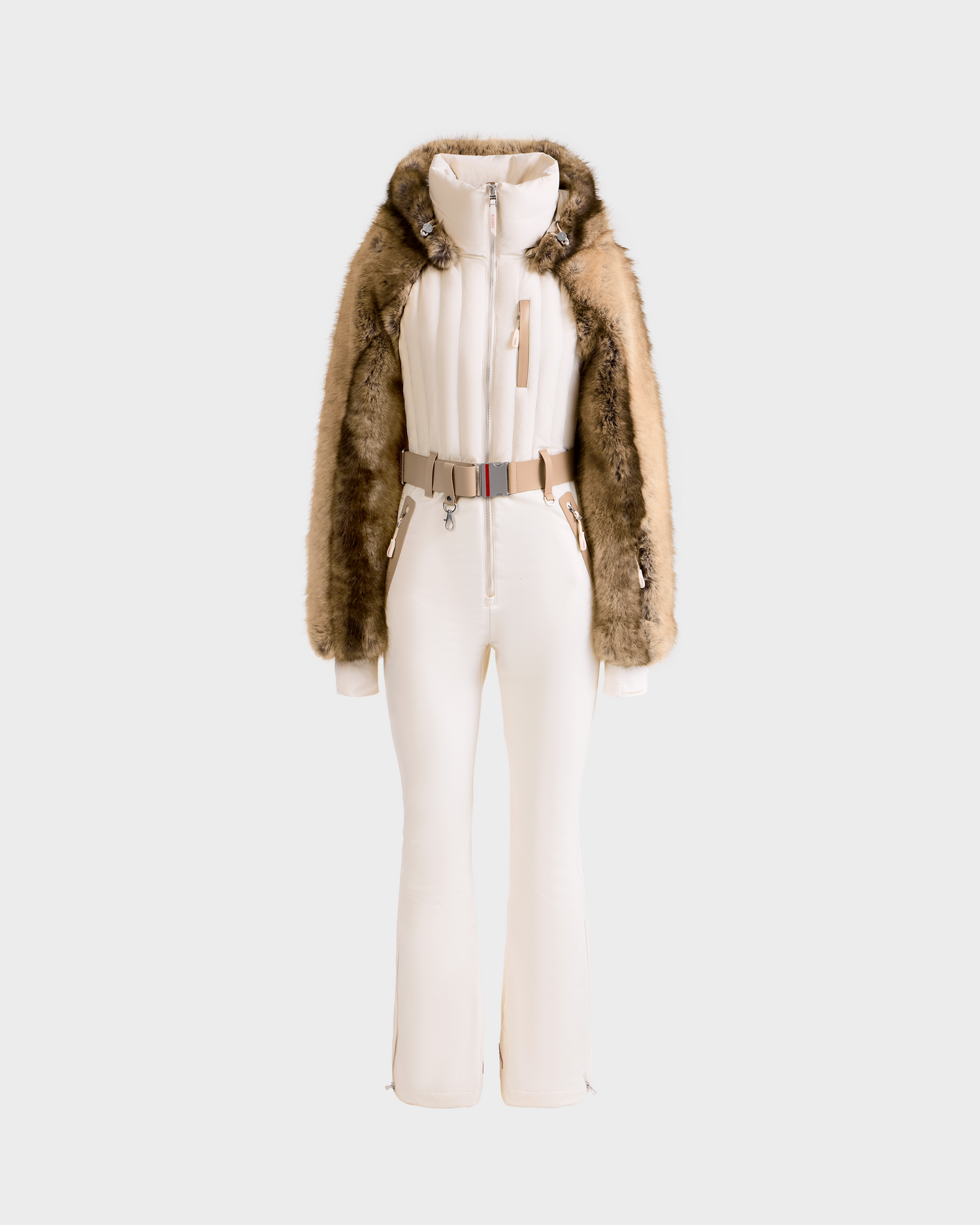 The Rudsak DESTINY - 8124727 Vanilla is a stylish women’s one-piece ski suit in fitted white, featuring a beige belt and a hooded jacket with brown faux fur sleeves and trim, displayed on a plain white background.