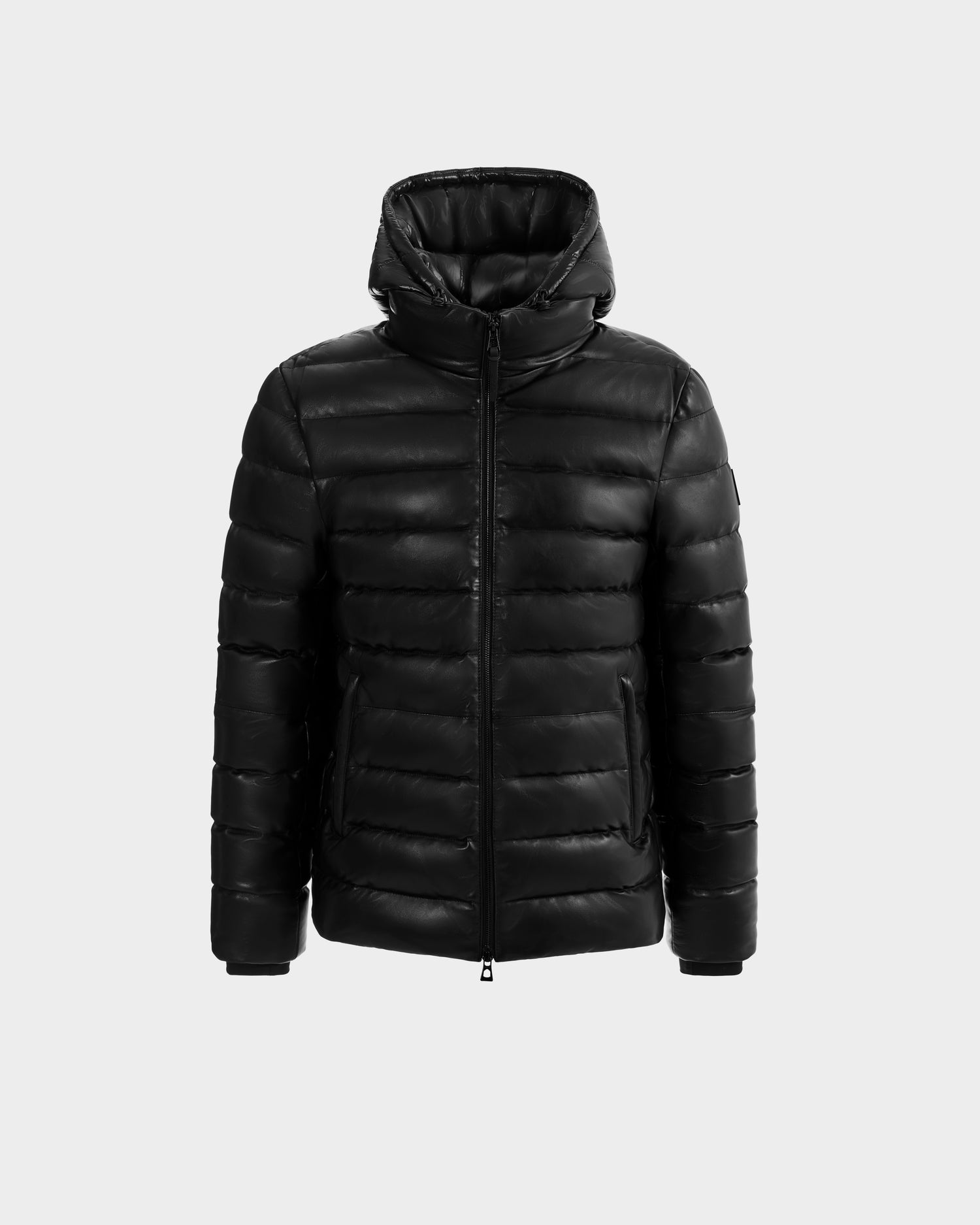 The Rudsak DRAVENX - 6125686 Black leather puffer jacket features a hood, front zipper, and two side pockets, shown on a plain light gray background.