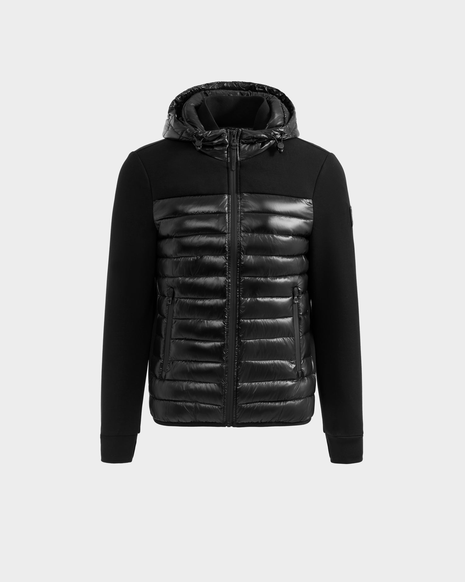 The Rudsak DURIN S - M125529 Black is a men’s hooded jacket with a shiny quilted front, zipper closure, and lightweight down insulation in the padded body and hood, contrasted by matte sleeves and upper chest.
