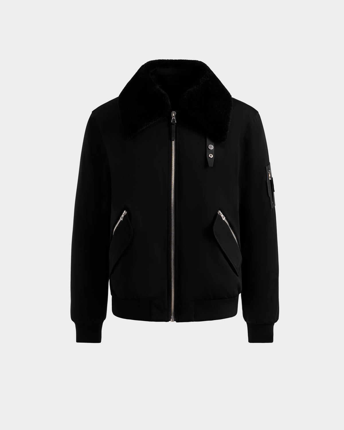 The DYLAN - 6125593 Black men's aviator bomber jacket by Rudsak features a large faux fur collar, front zipper closure, zippered side pockets, and a zippered sleeve pocket, shown on a light gray background—modern outerwear.