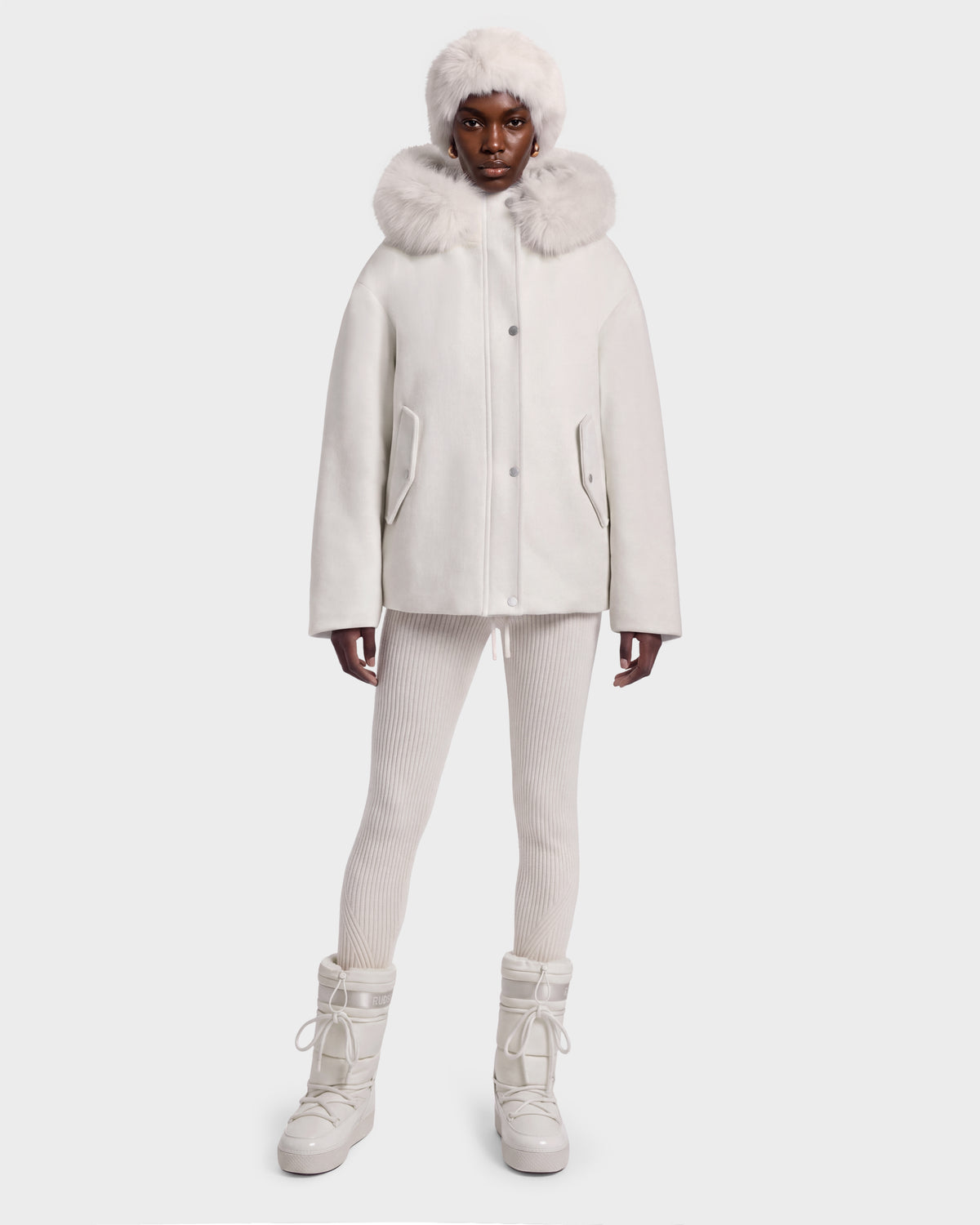 A model wearing a vanilla-colored HAZEL - 8126981 Rudsak wool-blend winter coat with a faux-fur trim, matching leggings, a faux-fur hat, and winter boots.