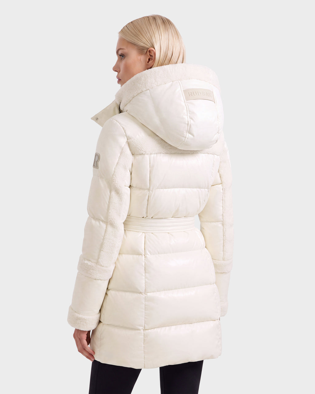 Back view of a vanilla Rudsak AUDREY L - 8124585 off-white belted down puffer jacket with a hooded fur-trimmed collar.