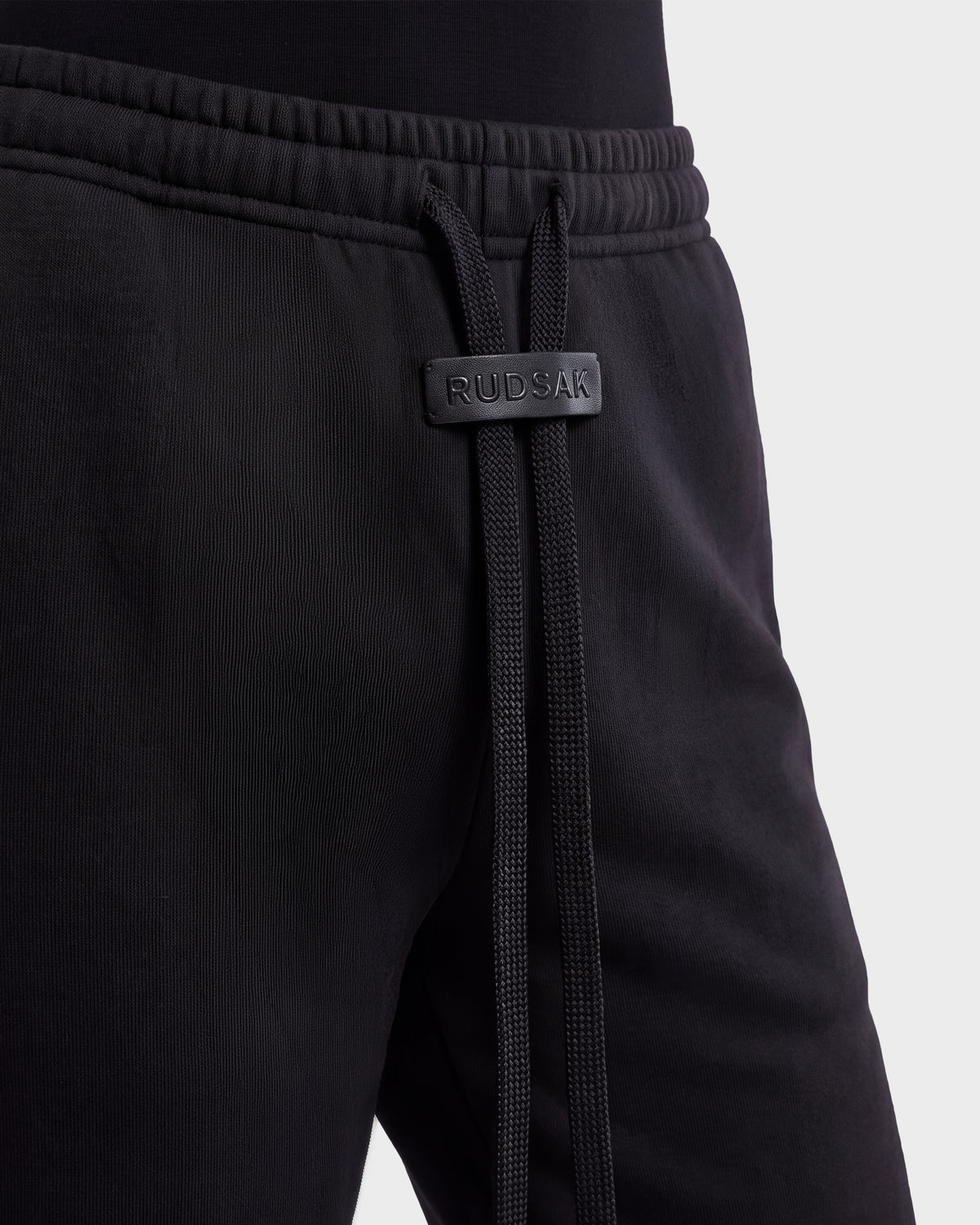 ANGEL - 8526725 Black stretch cotton sweatpants featuring an elastic waistband with a branded leather-like tab and long drawstring cords for a refined off-duty look.