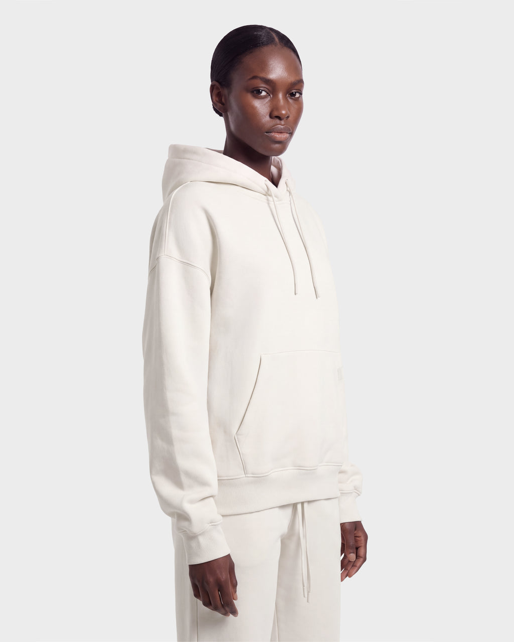 A person in the Rudsak MILENA - 8526689 Vanilla set stands against a light gray background, looking slightly to the side with a neutral expression.