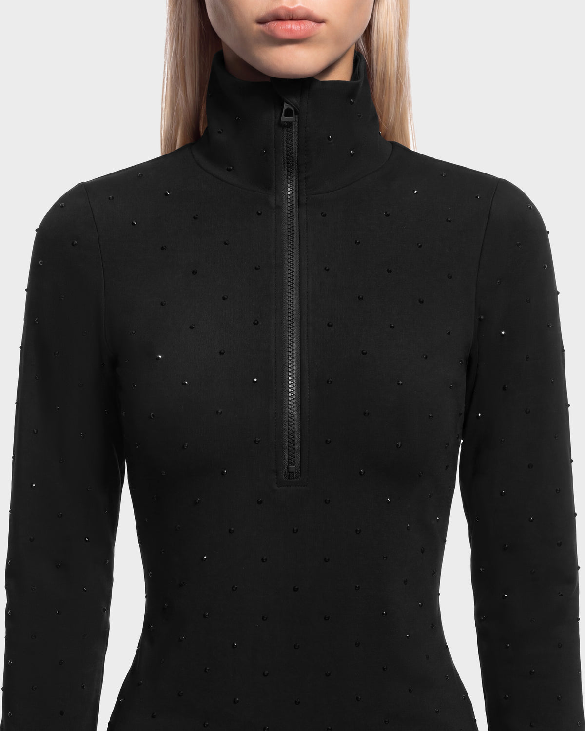 Rudsak NEVA - 8526524 Black long-sleeved après-ski top with a high collar, half-zip closure, and small dark studs across the front.