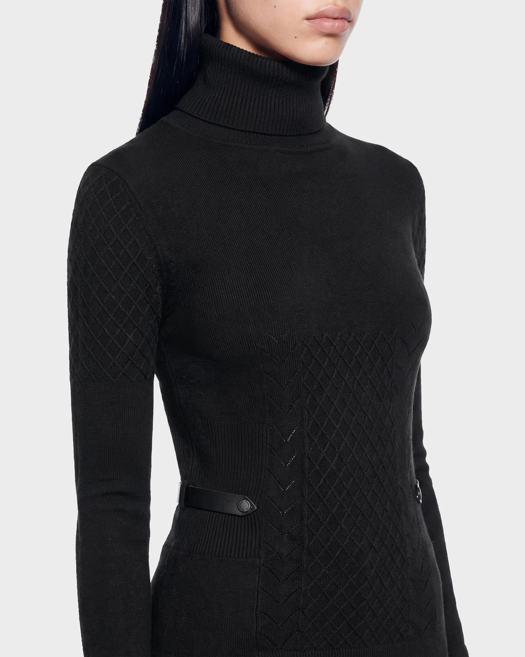 Rudsak LAURA - 8524596 Black long-sleeved knit turtleneck sweater with a diamond-patterned texture at the shoulders and front, finished with a narrow vegan leather trim strap at the waist.