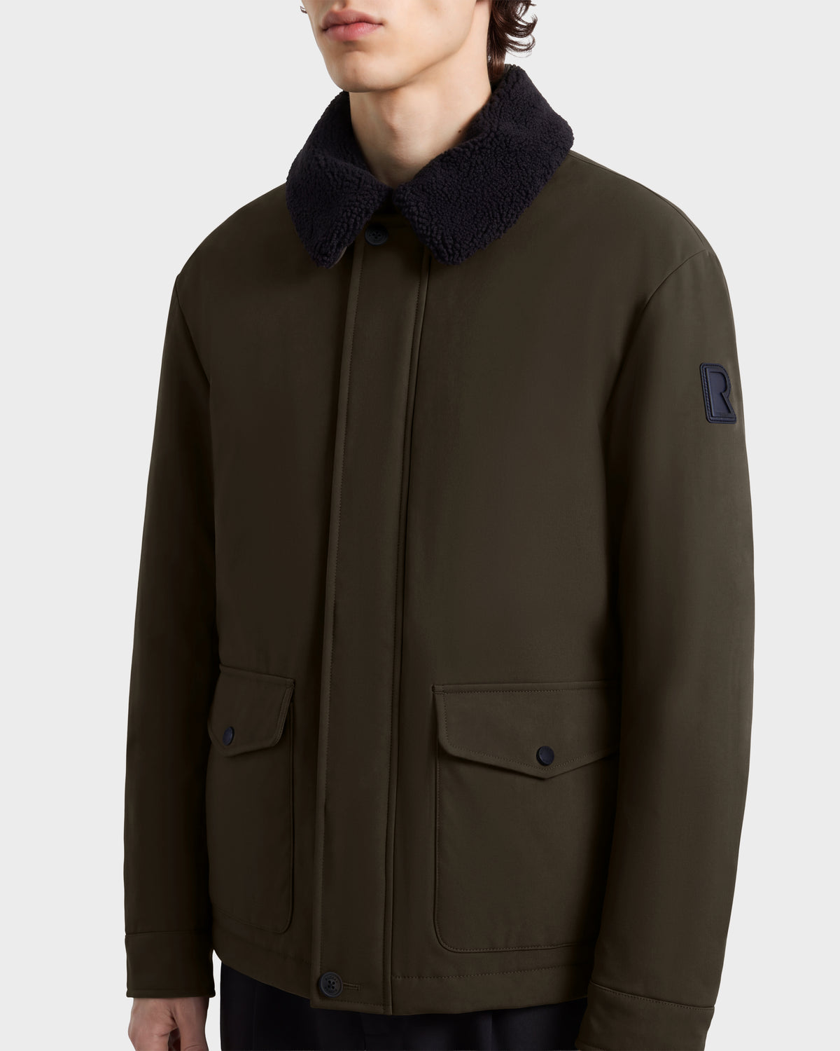 Rudsak ANTOINE - 6126506 Olive utility jacket in olive green with a dark faux-fur collar, hidden button placket, and two large front flap pockets.