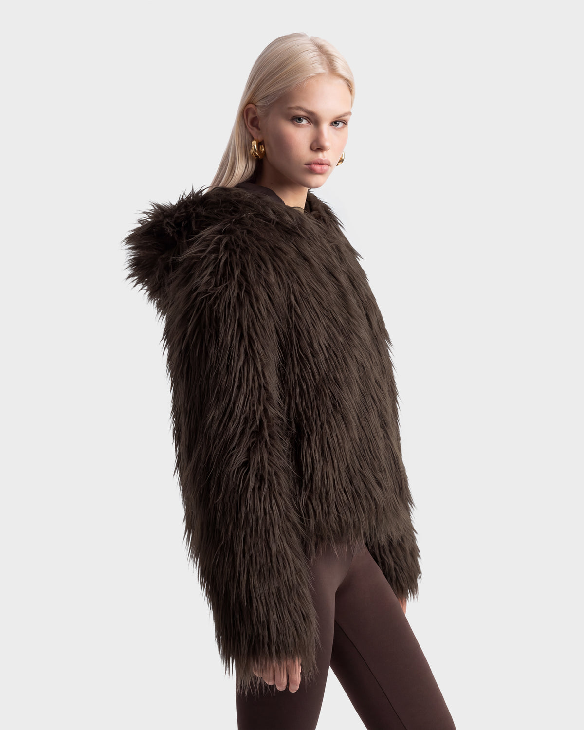 A person wearing an espresso ELLISON - 8525678 Rudsak dark brown faux fur hoodie with an oversized hood.