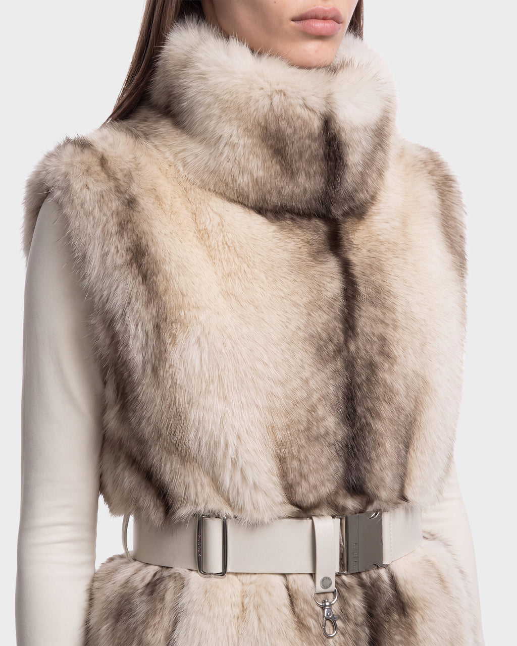 A Rudsak MAULIN - 8524611 Mix Vanilla high-neck, chic pullover faux fur vest featuring a light-colored pattern and a white buckled belt at the waist.