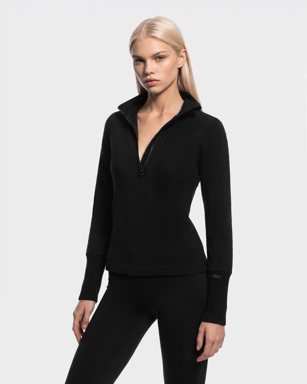 Rudsak NEVA - 8526524 Black fitted long-sleeve quarter-zip top with a high collar, subtle stud detailing, and a stretch nylon finish.