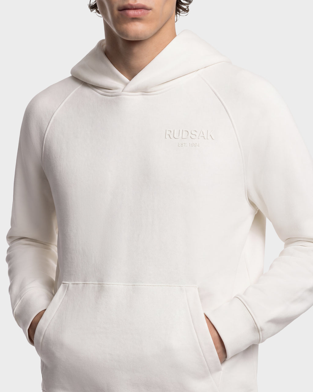 Off-white BRIAR - 9525001 Vanilla M unisex hoodie by Rudsak, featuring a front kangaroo pocket and a debossed logo on the chest.