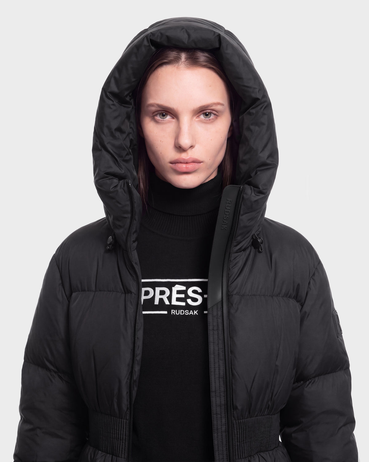 A person wearing the DIAMOND - 8126772 Black jacket by Rudsak and a black PRÉS. RUDSAK turtleneck stands against a plain light gray background.