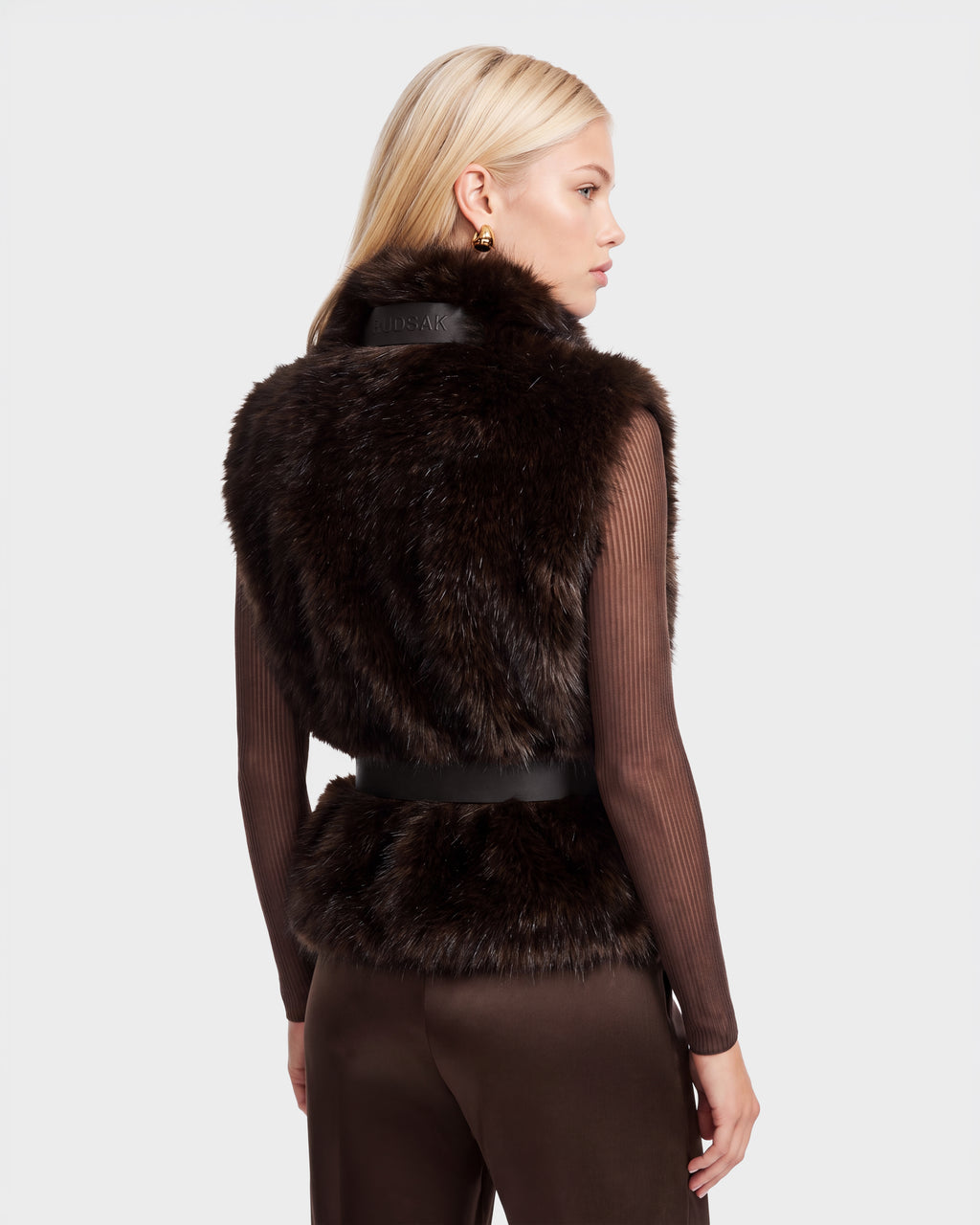 Woman wearing a dark brown MAULIN - 8524611 Mix Espresso faux fur vest over a long-sleeved ribbed mock-neck pullover.